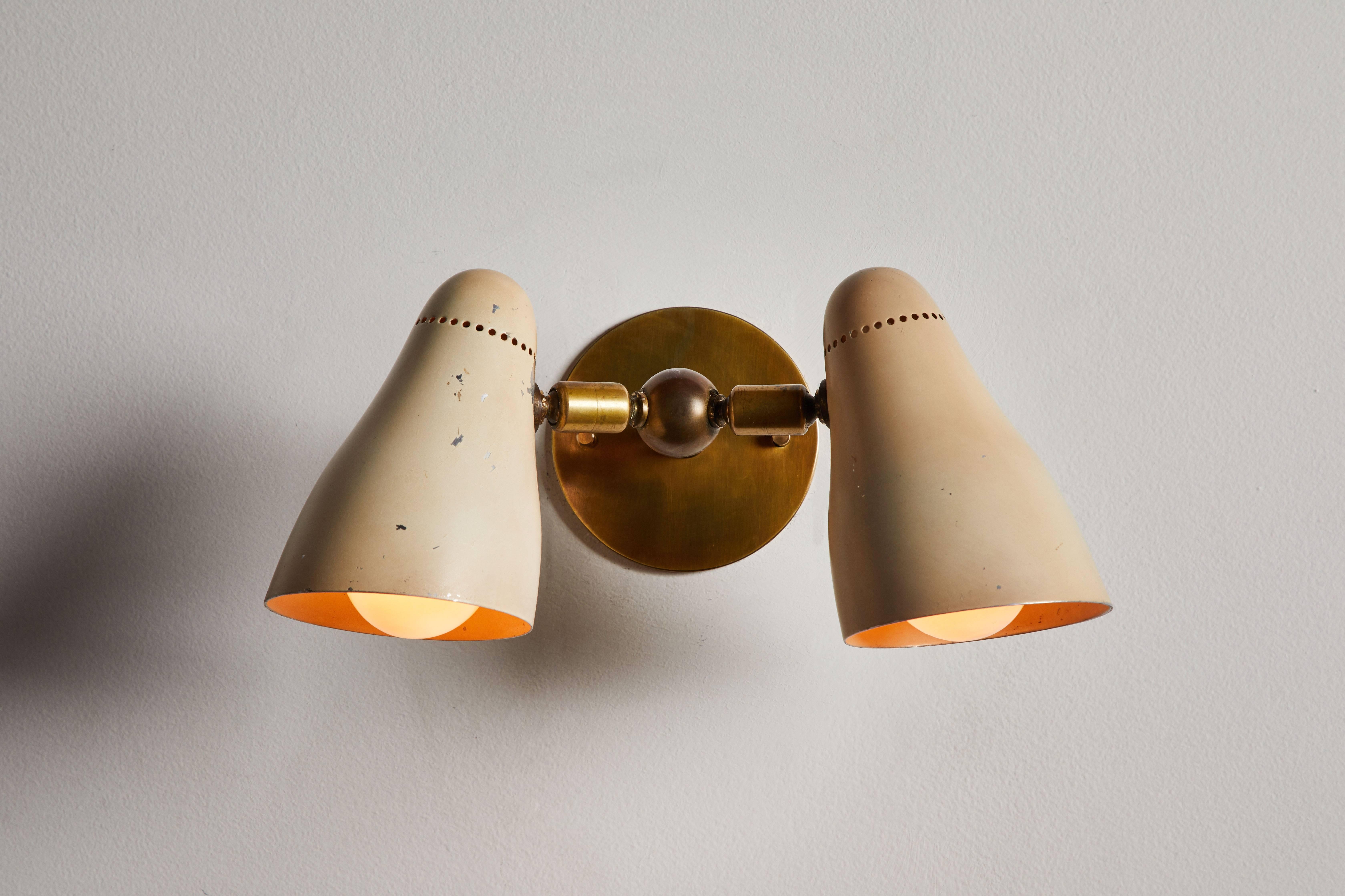 Pair of model 122 Doppia Vipera sconces by Giuseppe Ostuni for O-luce. Designed and manufactured for O-Light production in Milan, circa 1950s. Original enameled aluminium shades with articulating and pivoting brass arms. Custom brass backplate.