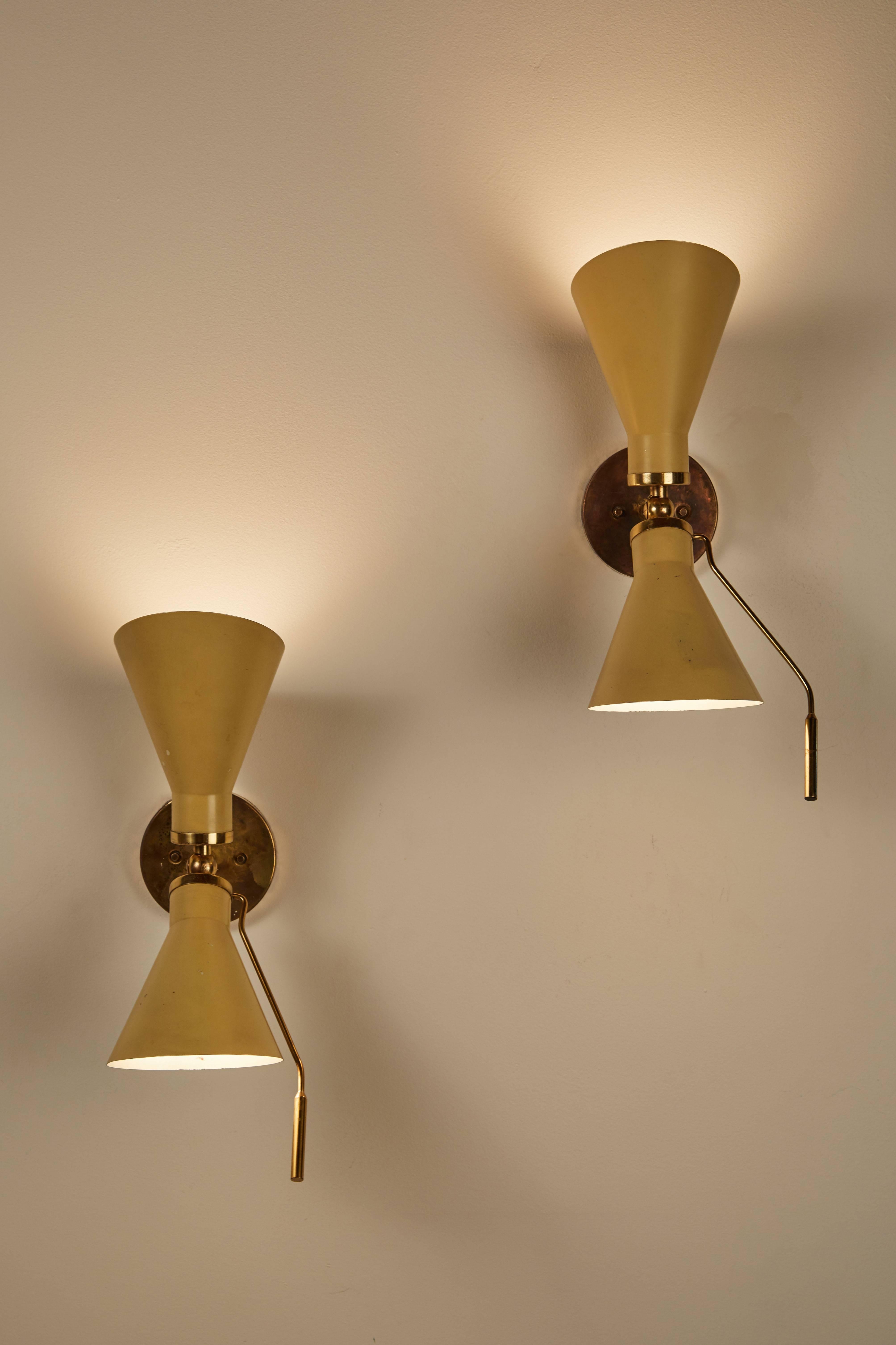 Pair of Model 131 articulating sconces by Gino Sarfatti designed in Italy, circa 1950s. Original backplates. Wired for US junction boxes. Each sconces takes an E14 75w maximum European candelabra. Literature: Gino Sarfatti Selected Works 1938-1973