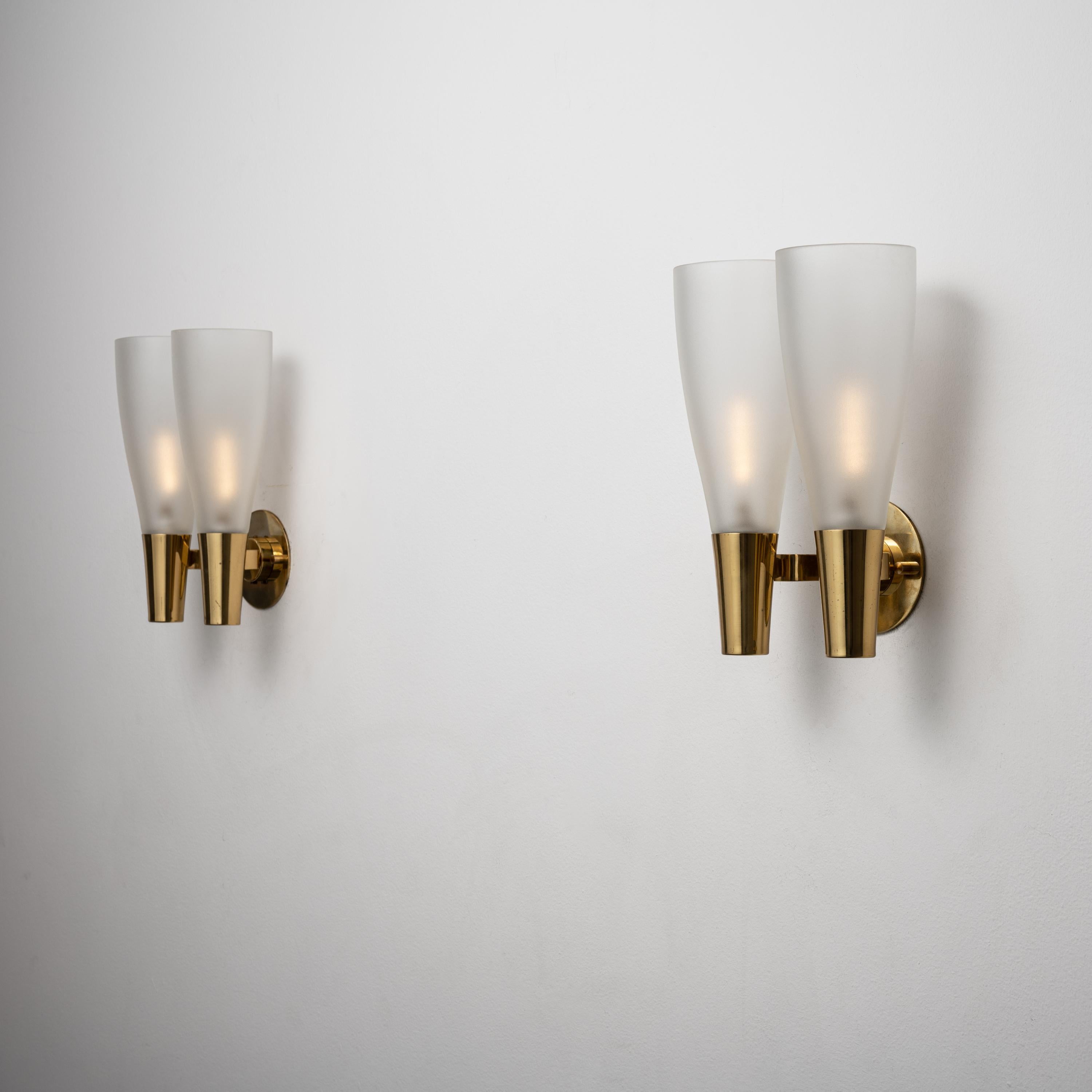 Pair of model 1537 sconces by Pietro Chiesa for Fontana Arte. Designed and manufactured in Italy, circa 1950's. Brass, glass. Rewired for U.S. standards. We recommend. Lamping: 120v 2 Qty E14 sockets with 40w frosted bulbs/ lightbulbs not included.