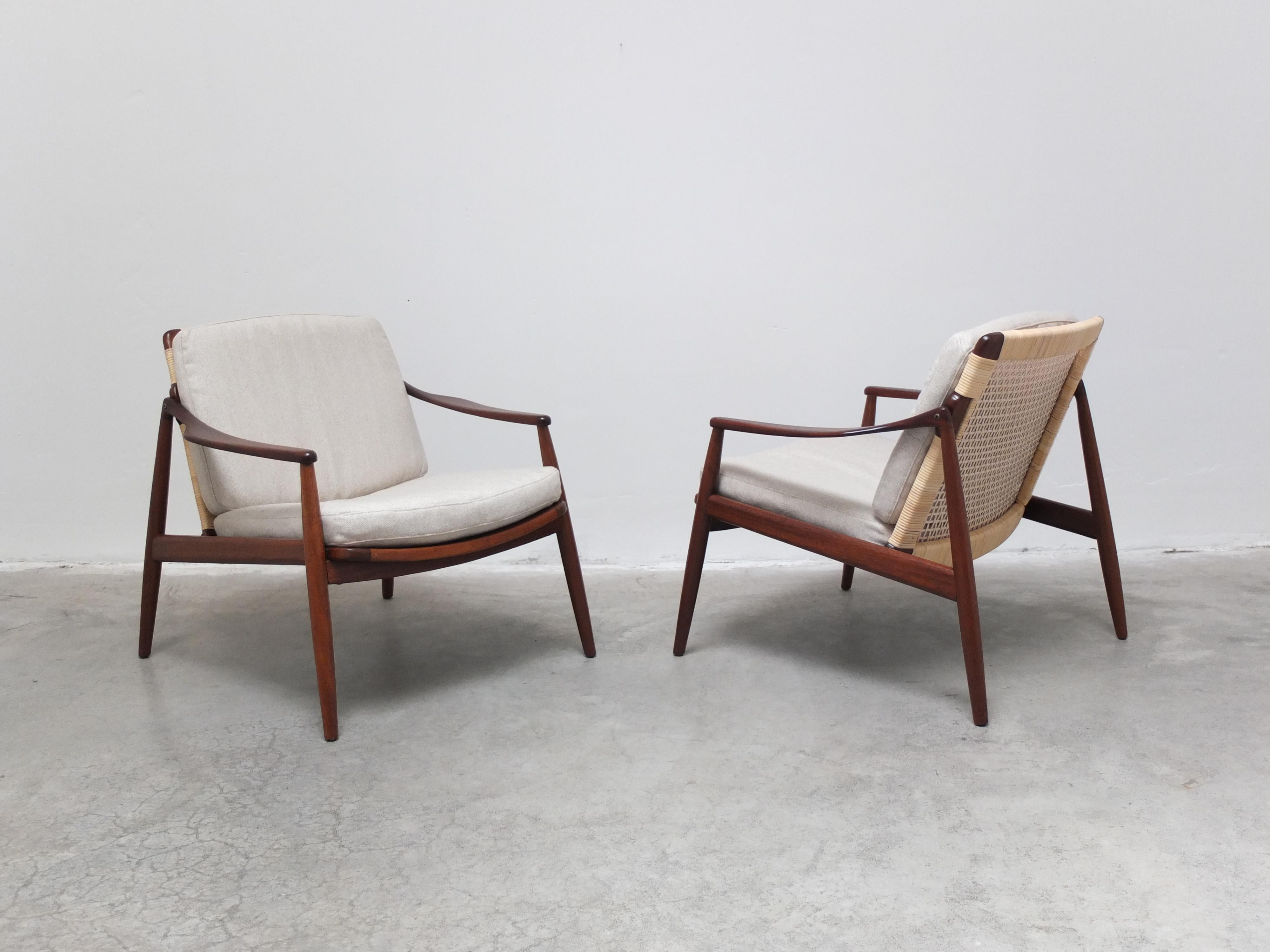 Beautiful pair of ‘Model 400’ easy chairs designed by Hartmut Lohmeyer for Wilkhahn around 1956.  Both the the teak frames and the cane back supports are fully restored. There are 2 cushions par chair which have been professionally reupholstered in