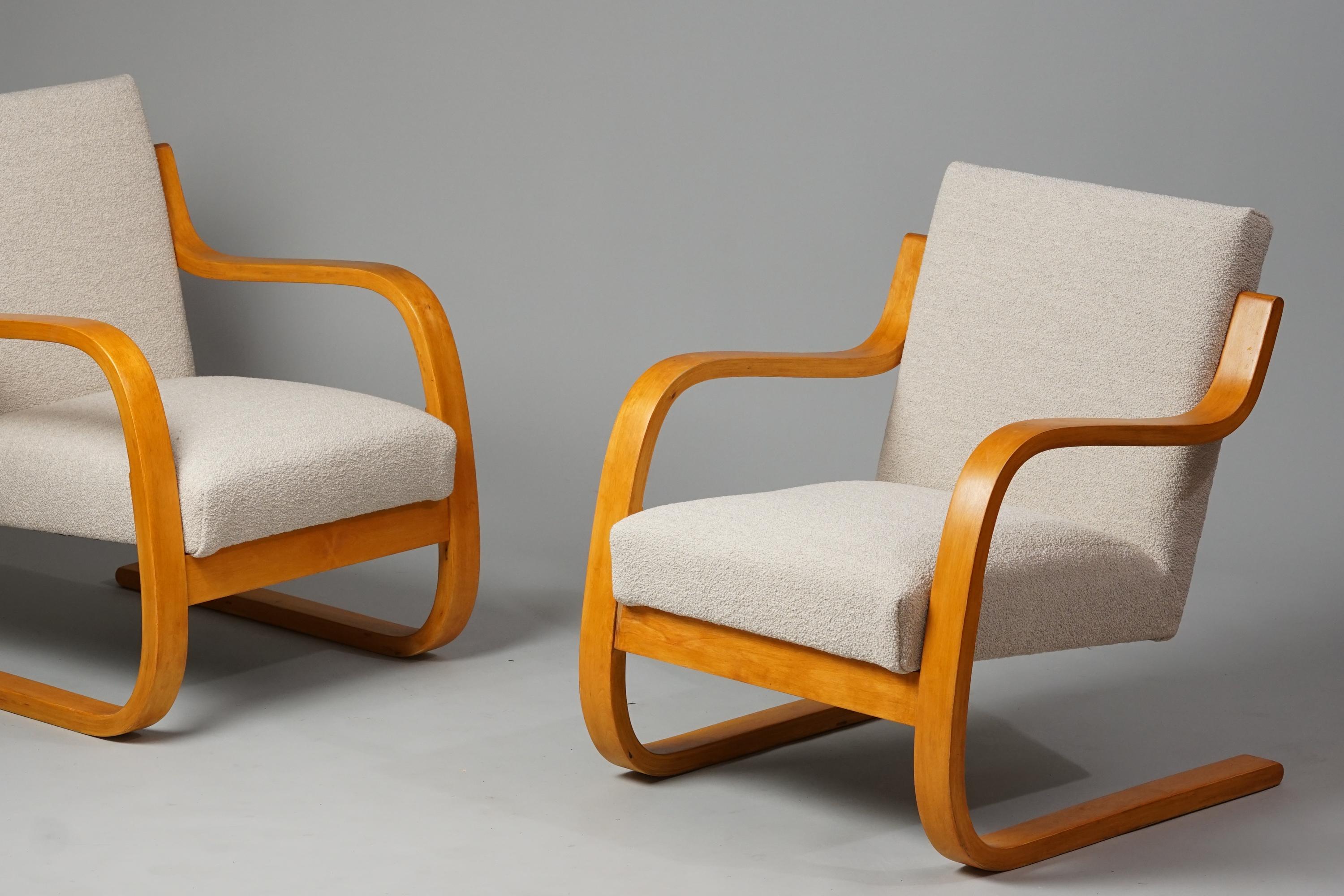 Pair of Model 402 armchairs, designed by Alvar Aalto, manufactured by Artek, 1950/1960s. Gorgeous honey color birch frame. Reupholstered with quality Lauritzons Orsetto 012-fabric. Restored. Gorgeous vintage condition, patina consistent with age and