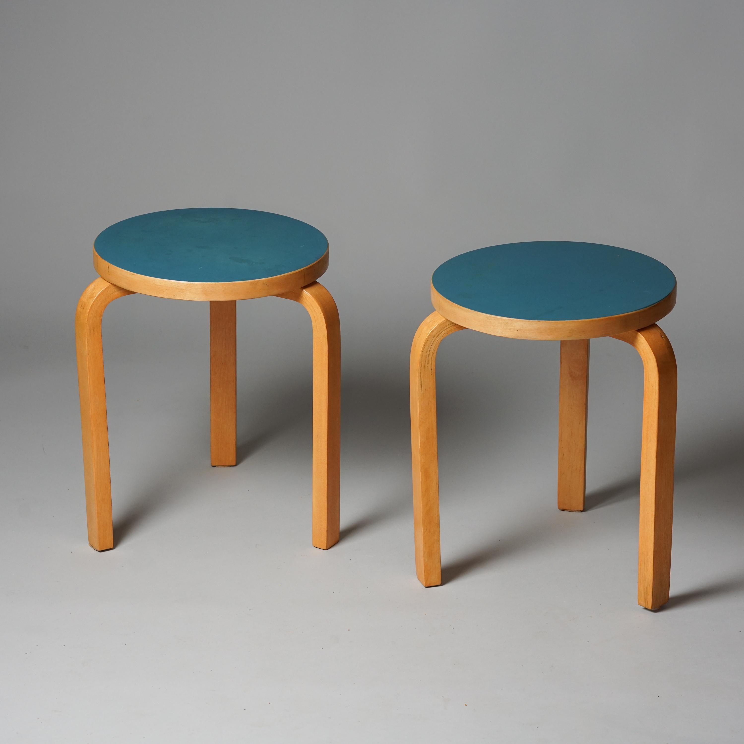 Pair of turquoise model 60 stools, designed by Alvar Aalto, manufactured by Oy Huonekalu- ja Rakennustyötehdas Ab, 1950s/1960s. Birch frame with turquoise linoleum top. Good vintage condition, minor patina consistent with age and use. The stools are