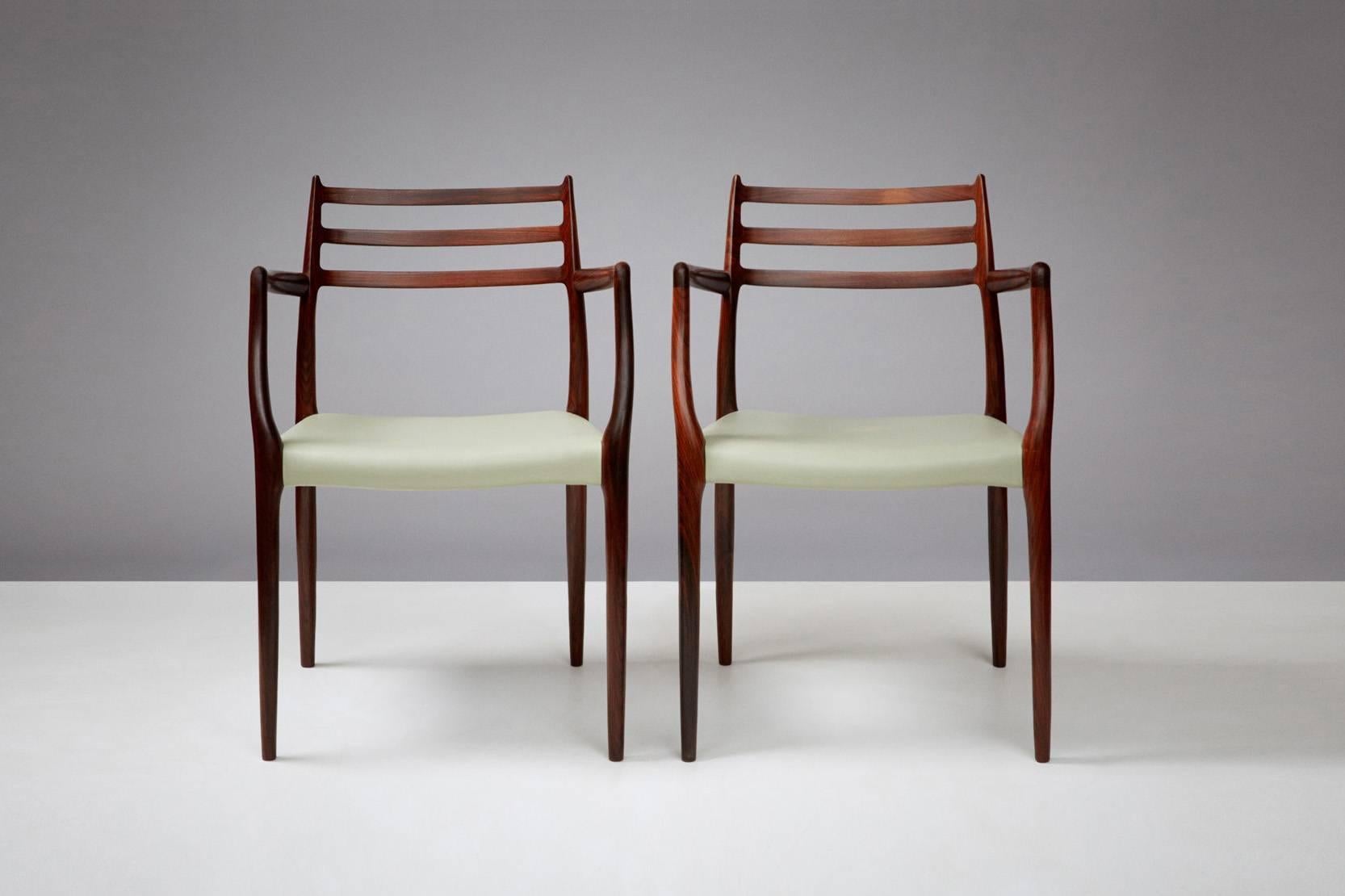 Rosewood armchairs produced by J.L. Mollers Mobelfabrik, Denmark, circa 1960s. Newly covered in pale green leather. Other upholstery options are available by request. 

Can be purchased in conjunction with sets of model 78 dining chairs that we
