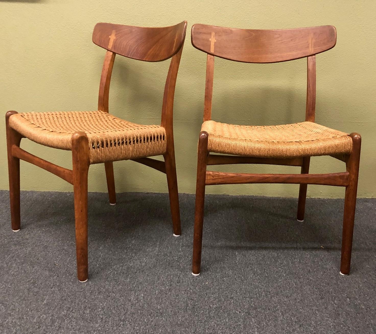 Gorgeous pair of Danish modern teak and oak Model-23 dining chairs with rope seats by Hans Wegner for Carl Hansen, circa 1960s. The frames have been fully restored and are very sturdy and solid. The rope seats are in great condition with no cuts or