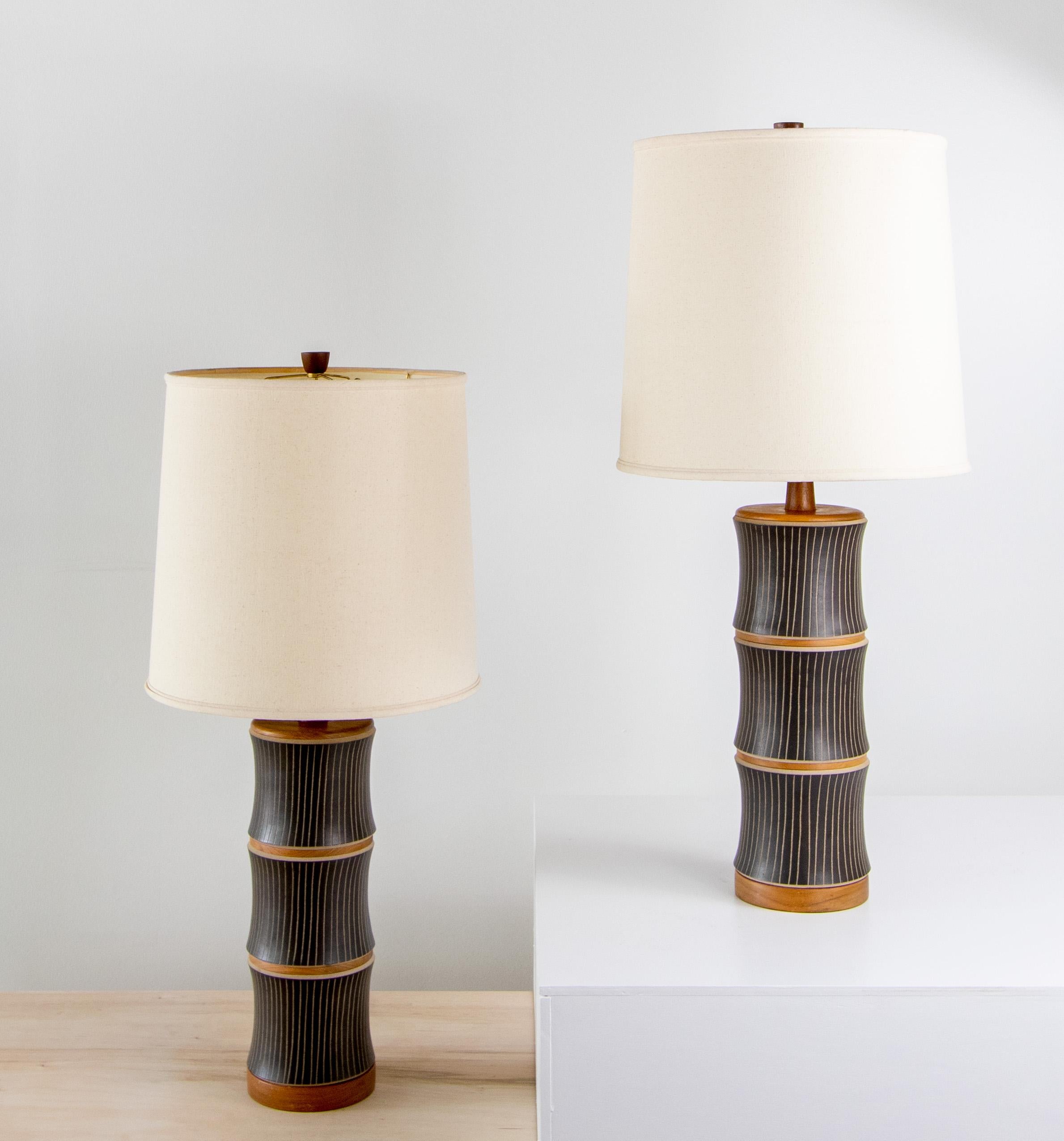 A pair of matte black model M221 lamps designed by Jane and Gordon Martz of Marshall Studios in Veedersburg Indiana. These lamps are highly sought after and are showing up in designs all over the world. Blending sophistication and modern these lamps