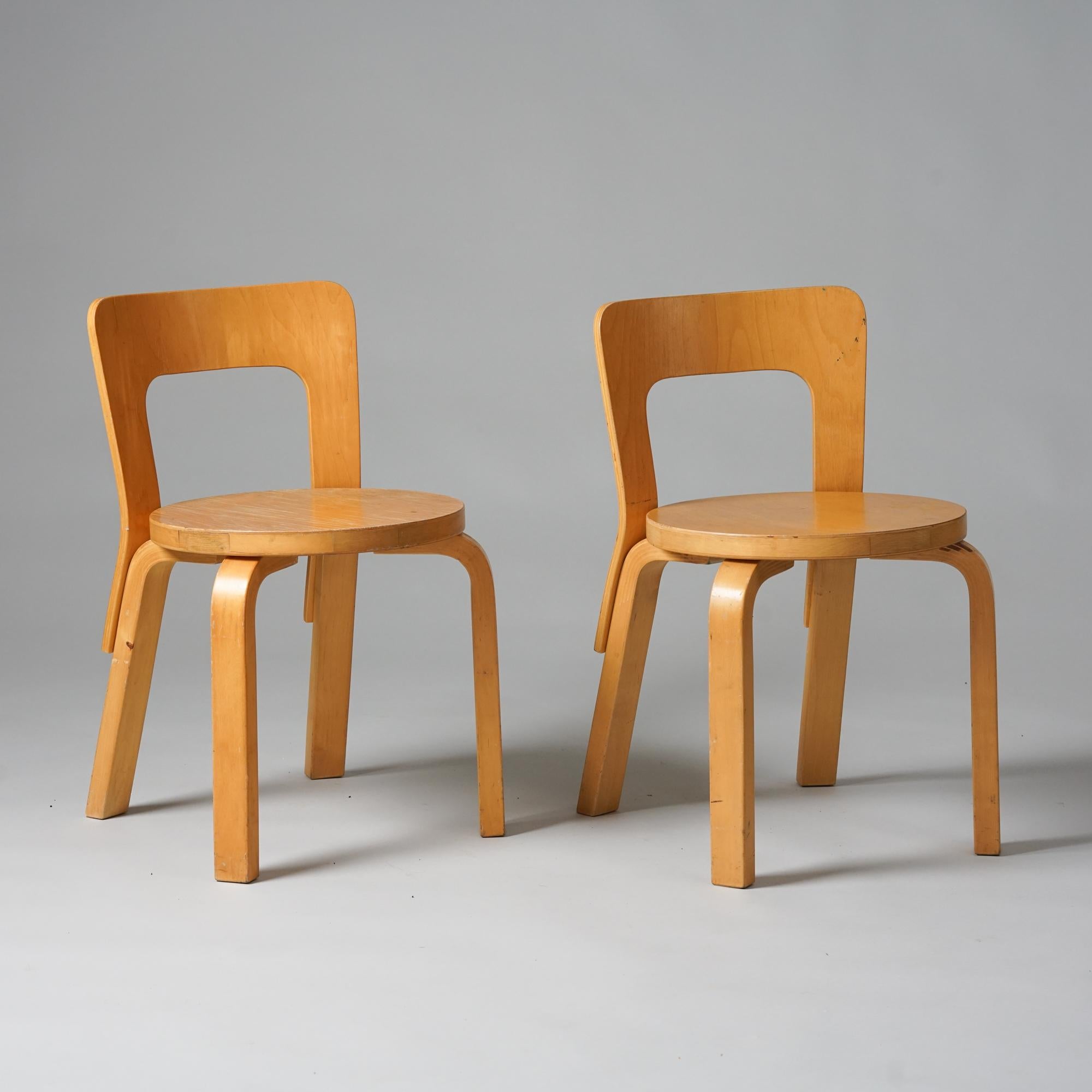 Pair of model N65 children's chairs, designed by Alvar Aalto, manufactured by Artek, 1960s. Honey colored patinated birch. Good vintage condition, patina and minor wear consistent with age and use. The chairs are sold as a set. 
Alvar Aalto