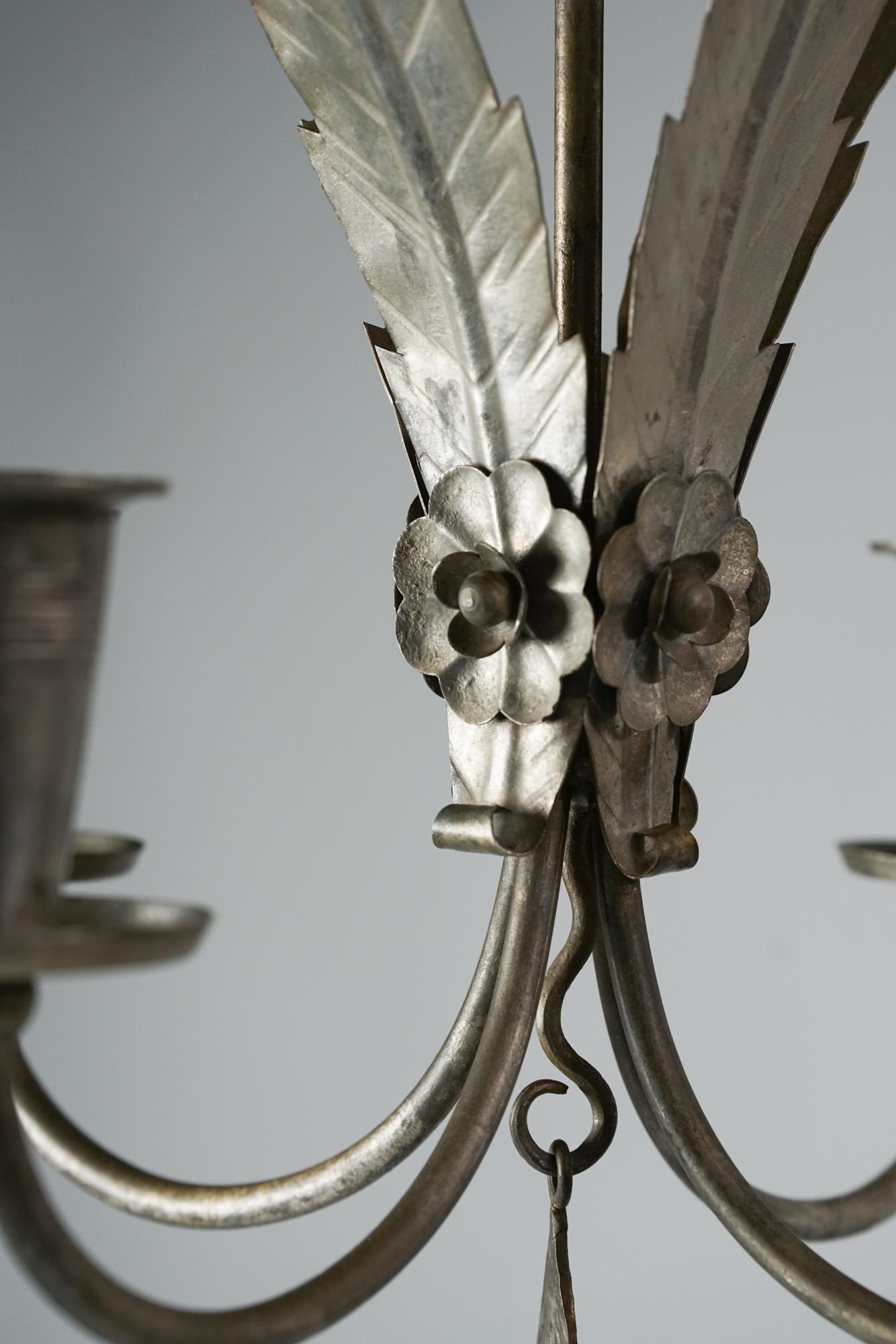 Pair of model R3/1703 chandeliers by Paavo Tynell for Taito Oy from the 1930s. Tinplated forged iron. Beautiful leaf and flower details. The chandeliers are sold as a set. Good vintage condition, patina consistent with age and use.