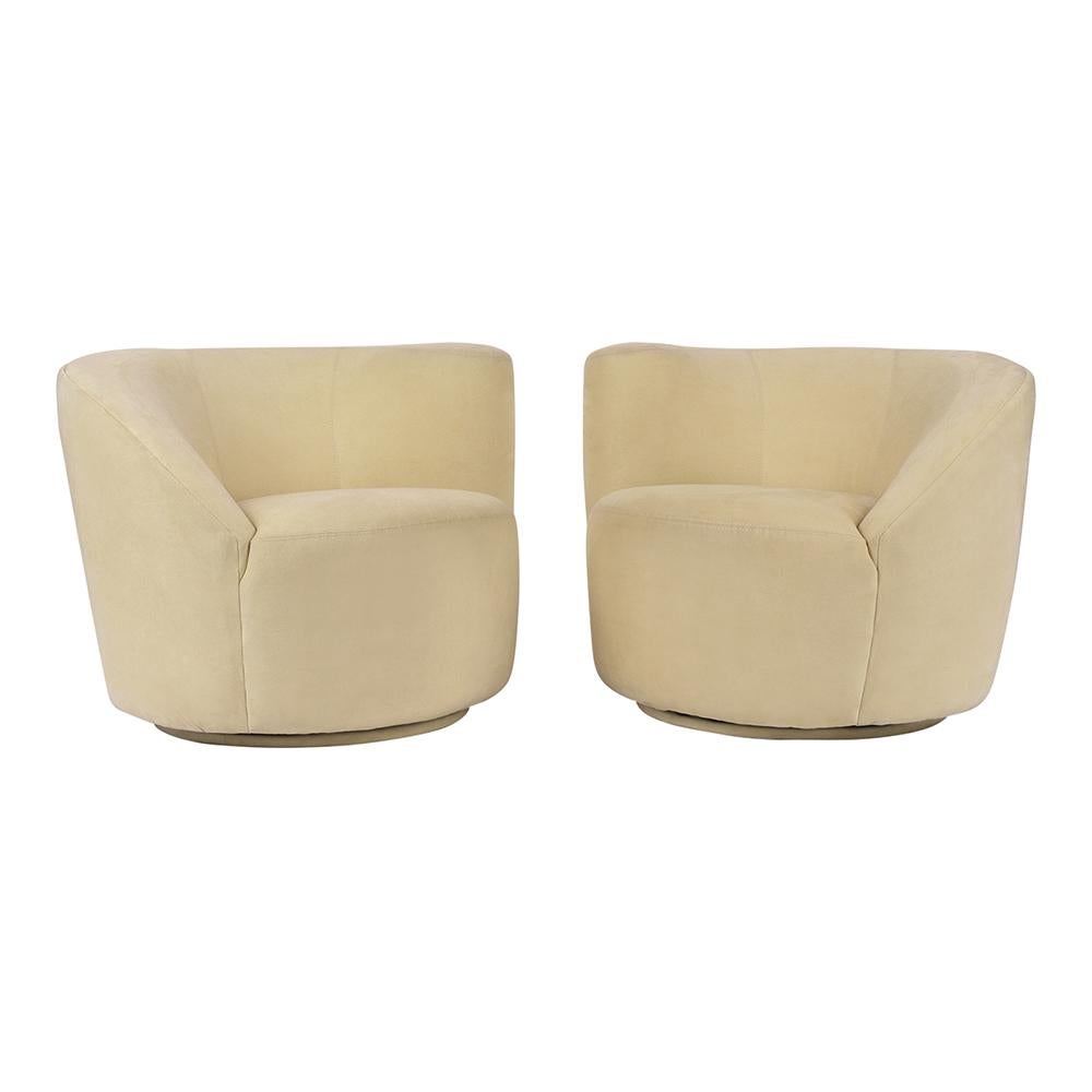 This pair of Vladimir Kagan style Swivel lounge chairs are upholstered in the original ivory ultra-suede fabric with topstitch details. The lounge chairs have a uniquely designed back & armrest and seat that make these chairs very comfortable. They