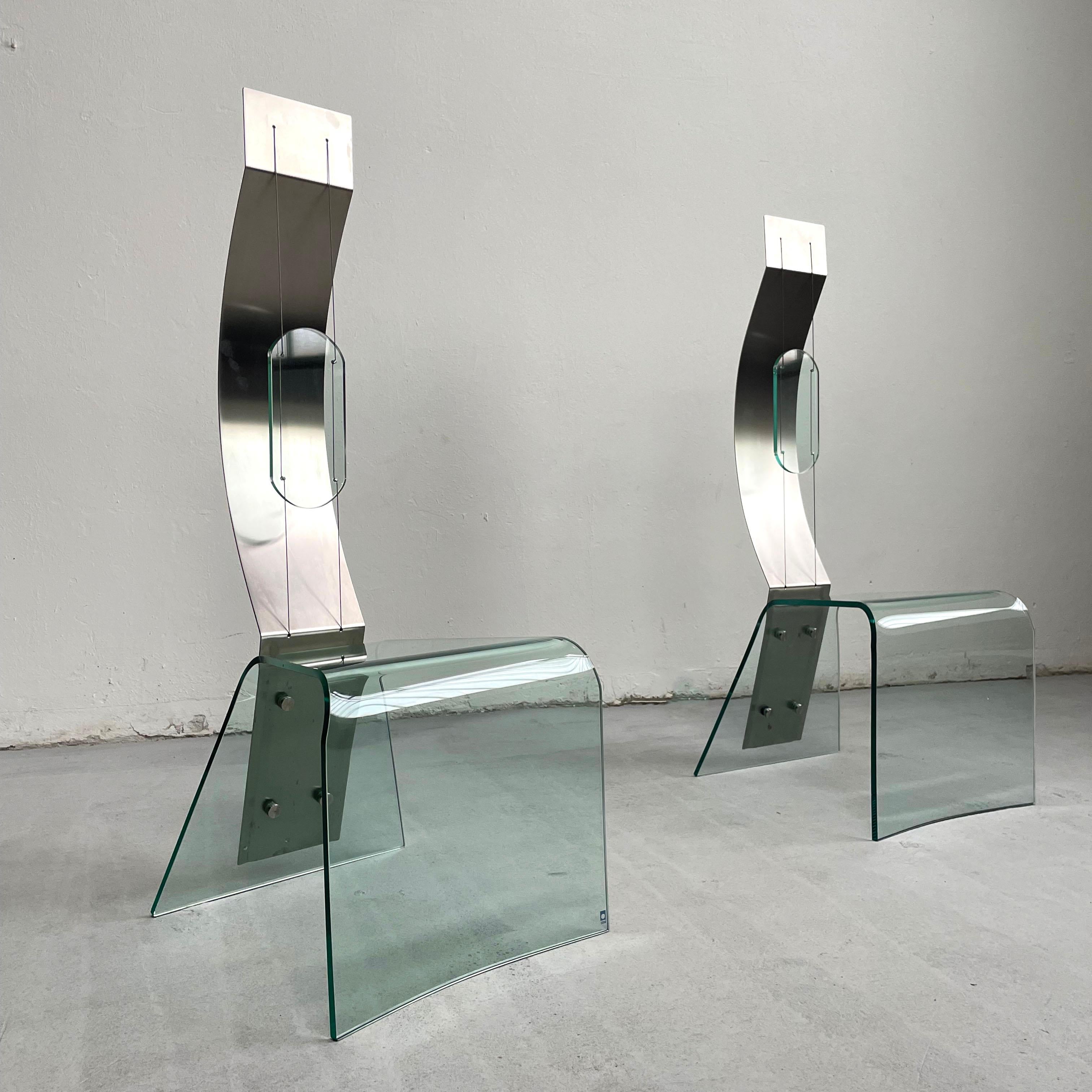 Stunning pair of architectural shaped chairs made of glass and steel from the late 20th century (circa 1980s-1990s)
Unique design reminiscent of the Japanese contemporary design of the 1980s

One chair has a small stamp, labeled 'Zero'.



