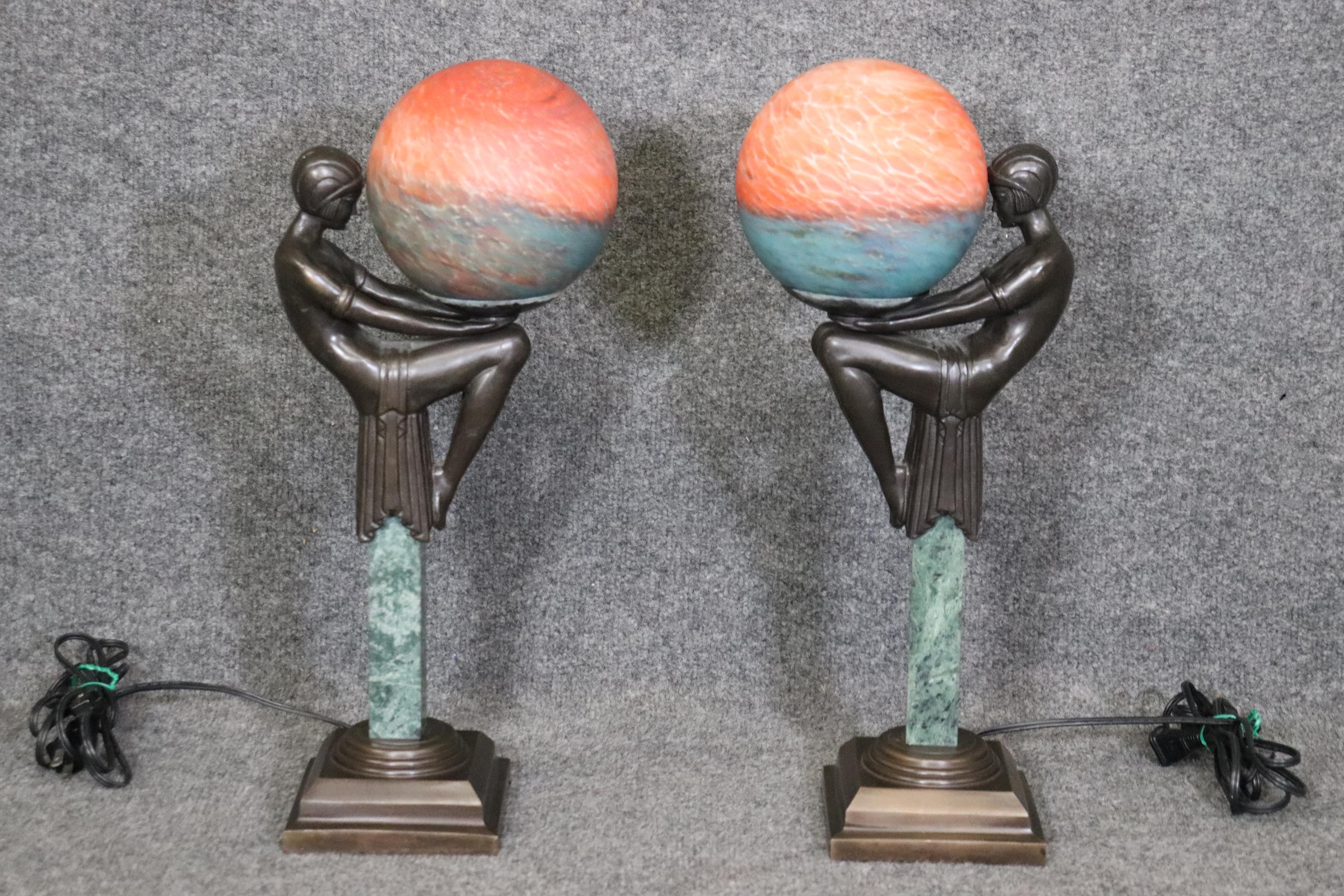 Dimensions- H: 18 3/4in W: 8 1/4in D: 5 1/4in 

This vintage Mid Century pair of Art Deco figural dancer table lamps with art glass shades is truly an interesting example of minimalistic yet luxurious decor. This pair of lamps are crafted of the