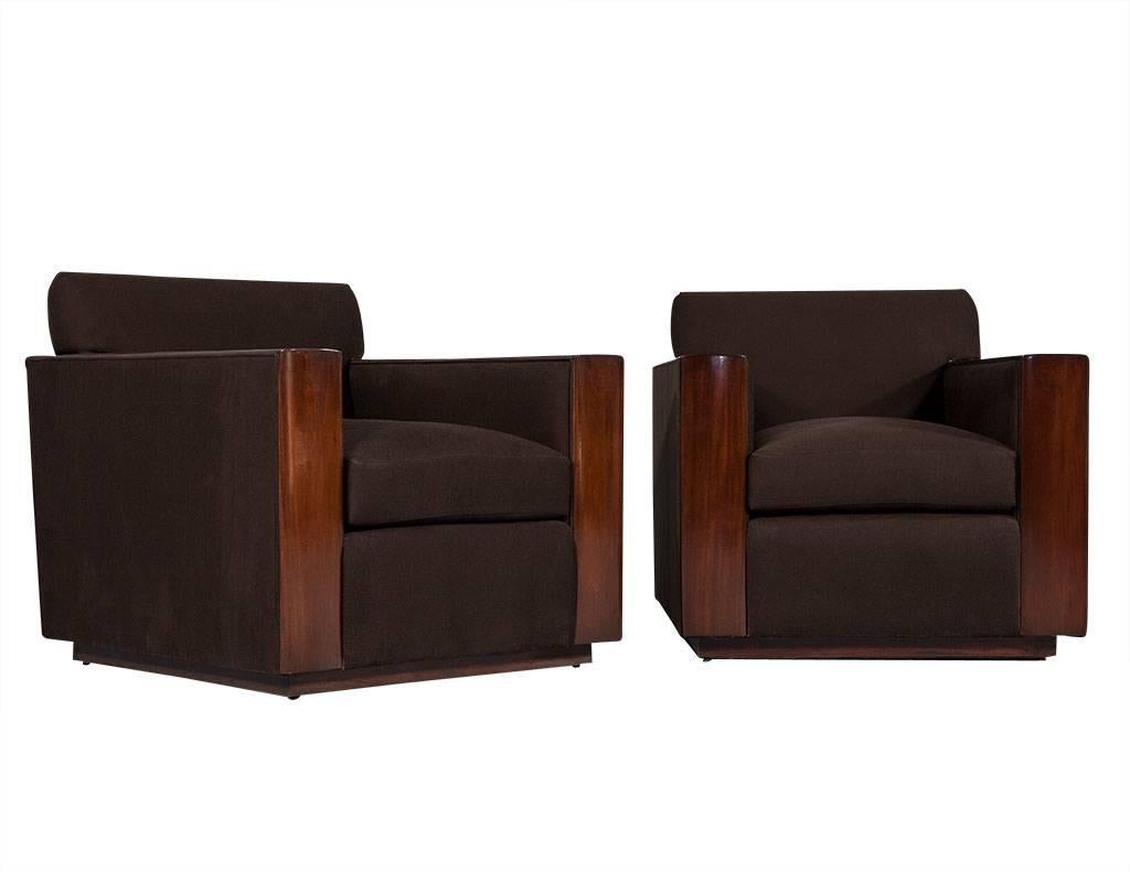 Pair of modern Art Deco inspired club chairs Brook Street by Ralph Lauren. An elegant pair of club chairs featuring mahogany accents with mohair down cushions. Modern sleek Art Deco influenced design accentuated with a hand polished mahogany