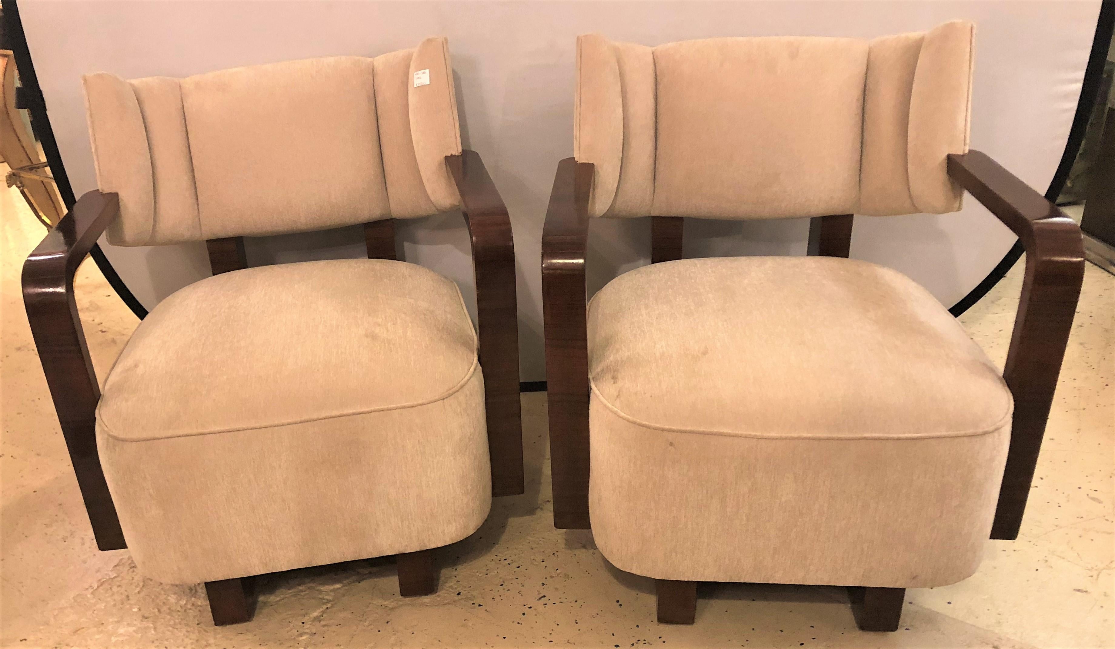 Pair of Modern Art Deco rosewood club chairs. Each having been finely hand rubbed French polished. Each with a rosewood frame supporting the back and seat rest as well as having full rosewood arms and runners. Strong and sturdy. 

Measures: 31.75