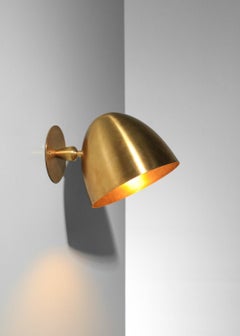 Modern bell-shaped sconces in patinated solid brass