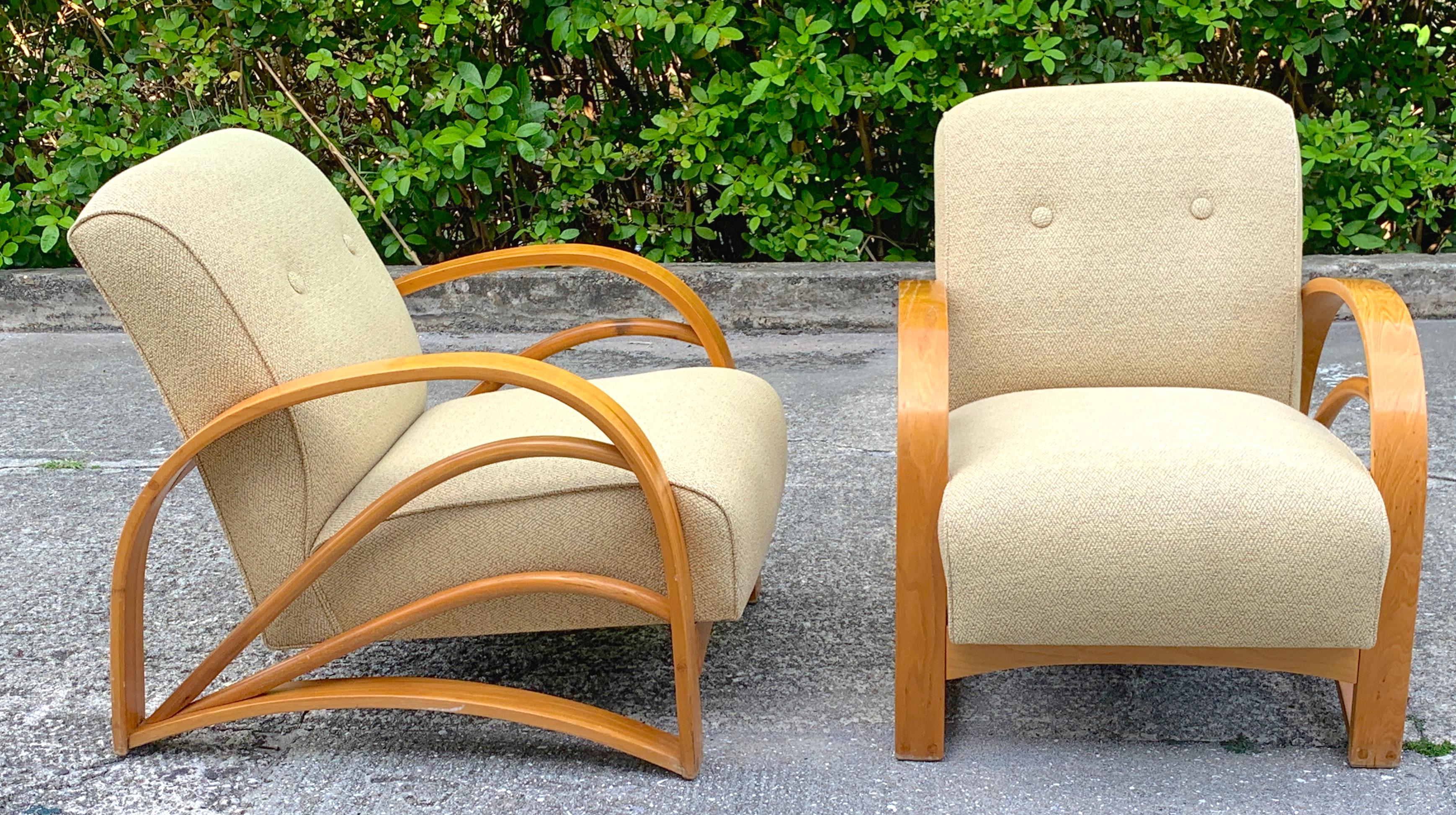 Pair of modern birch club chairs in the style of Paul Frankl, each one recently reupholstered, with sleek open arm rests. Each chair stands 29