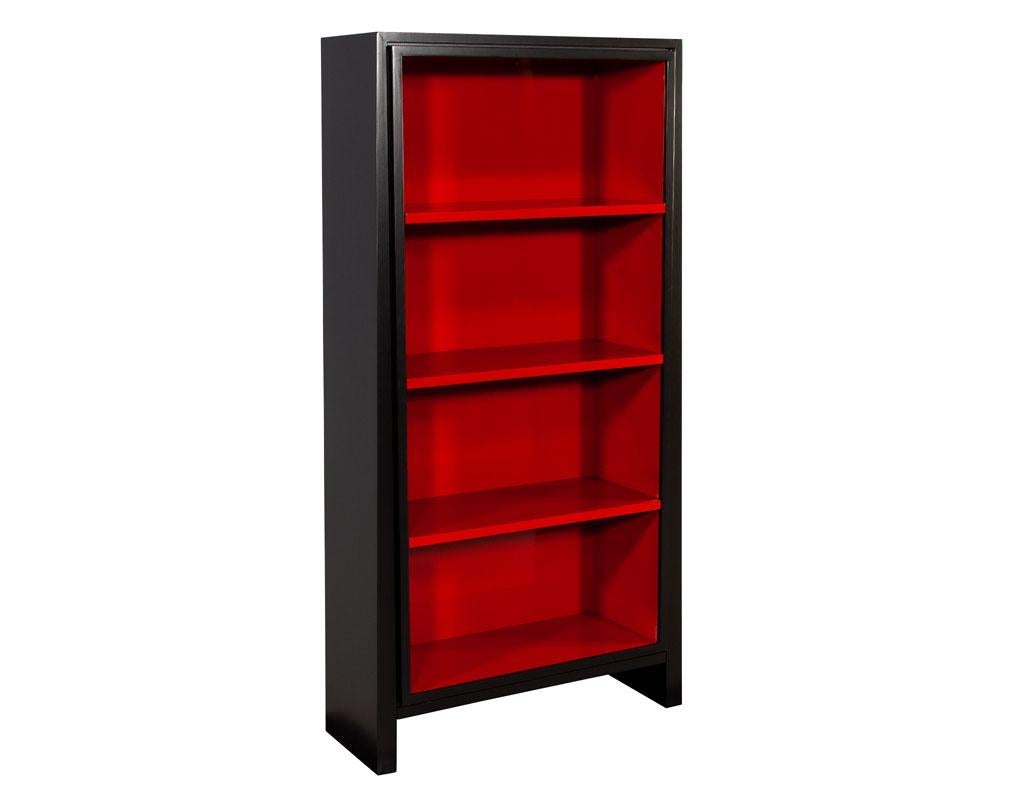 Pair of Modern black and ruby bookcases. Custom finished with a satin black exterior and ruby high gloss interior. Made in USA and custom finished by the artisans at Carrocel. Each bookcase has 3 Shelves all adjustable in 3 height positions. Price
