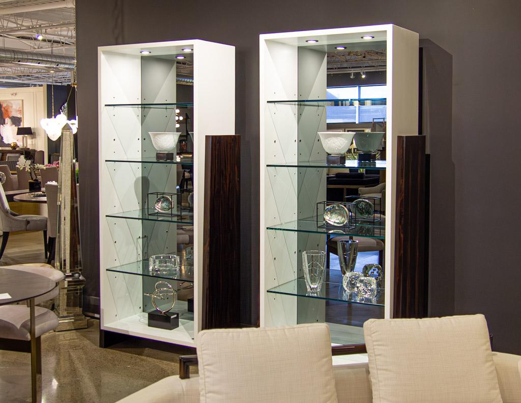 These sleek and modern bookcase display cabinets are the perfect addition to any home. Crafted with luxurious hand polished ziricote wood sides and satin white lacquer, the cabinets offer an upscale touch to any décor. They feature thick glass