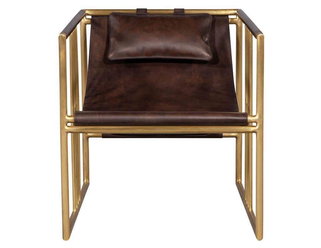 Pair of modern brass leather lounge chair Bison by McGuire Haybine. Sharply designed brass geometric shape with a beautifully sculpted distressed leather and attached pillow all delicately handstitched.

Price includes complimentary scheduled curb