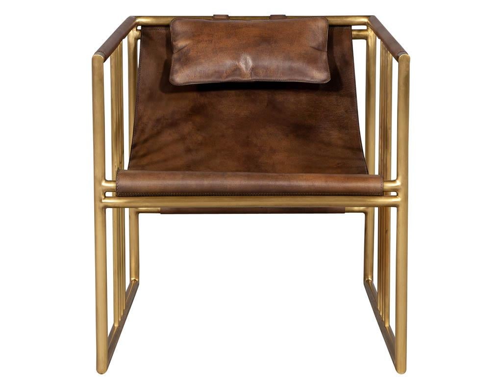 Pair of modern brass leather lounge chair saddle by McGuire Haybine. Sharply designed brass geometric shape with a beautifully sculpted distressed leather and attached pillow all delicately hand stitched.

Price includes complimentary scheduled