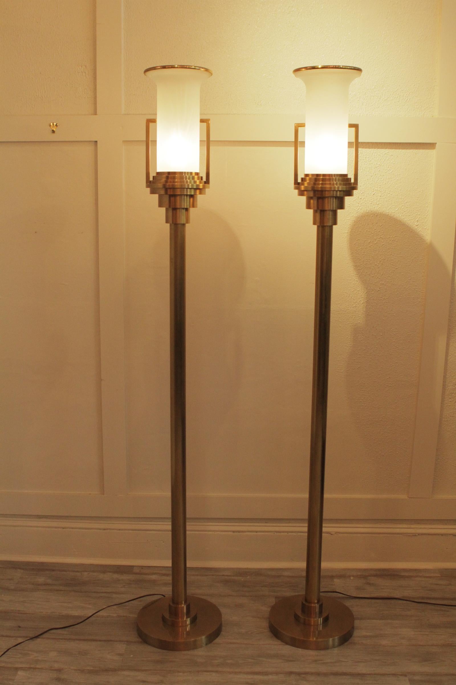 Pair of modern brass torchere floor lamps 20th century with frosted and gilt glass shades, Price is for THE PAIR
 Dimensions: 71.5” H x 8” D x Base 11.5 D.