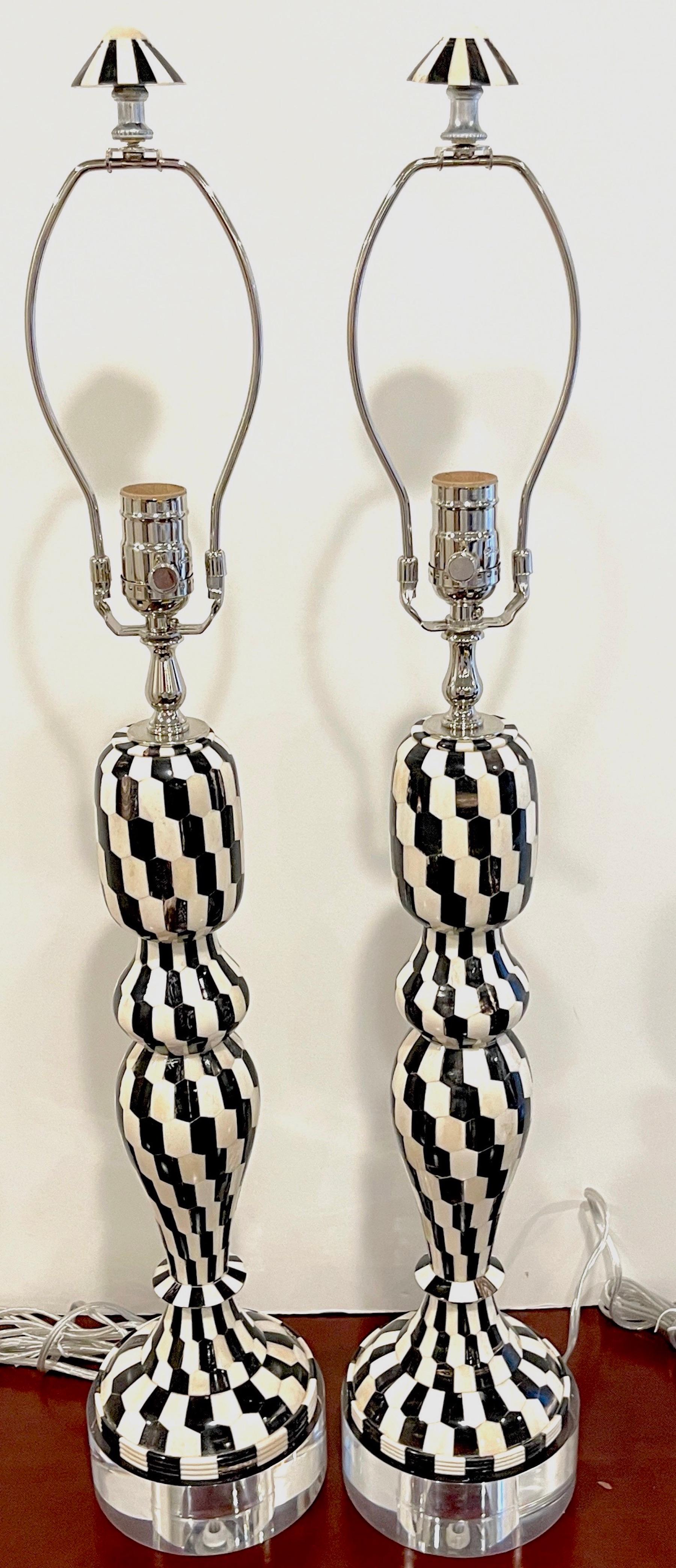 Pair of modern chevron pattern black & white tessellated stone & lucite lamps.
Complete with harps and matching finials 

Each one undulating column, inlaid with a black and white tessellated black and white stone mosaics, arranged in the