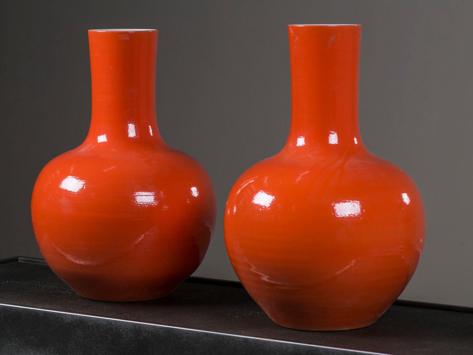 A pair of enormous modern Chinese ceramic vases glazed in an intense persimmon color made entirely by hand in China. The fantastic large-scale of this pair of Chinese vases is impressive as is the hand applied glaze with its dimpled texture. Please