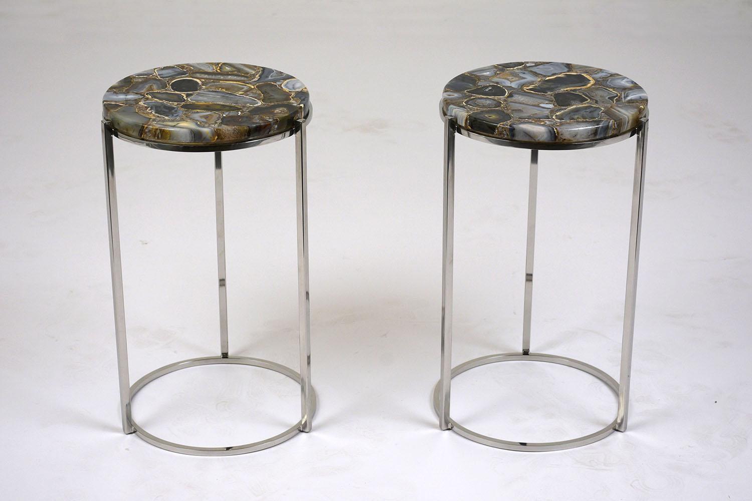 This pair of 1970s Mid-Century Modern round side table feature a chrome-plated steel frame. The top of the tables features a beautiful agate inlaid stone. This pair of side table is sturdy, stunning, and ready to be used for years to come.