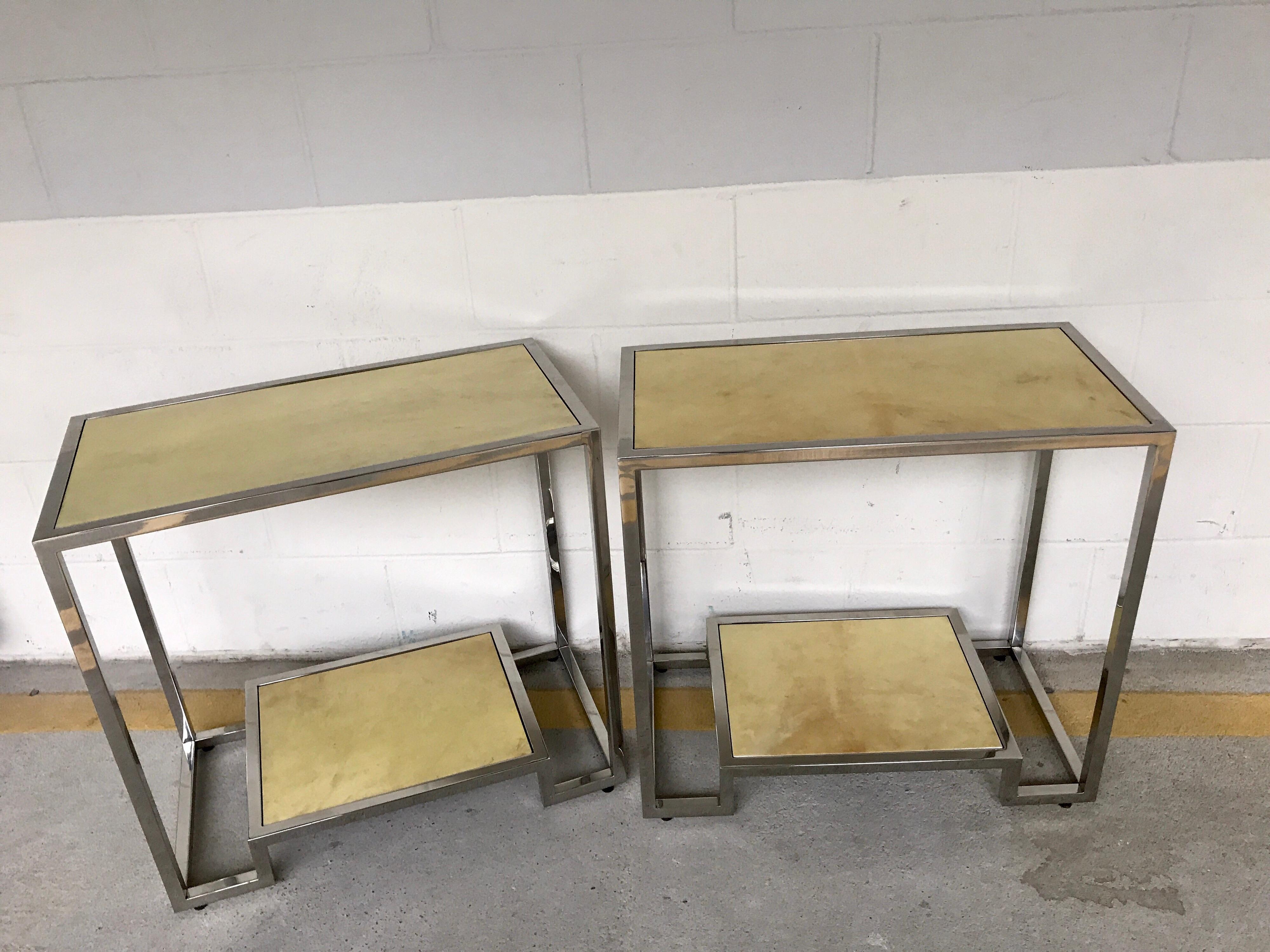 Pair of modern chrome and parchment two-tier side tables, each one with an upper 24
