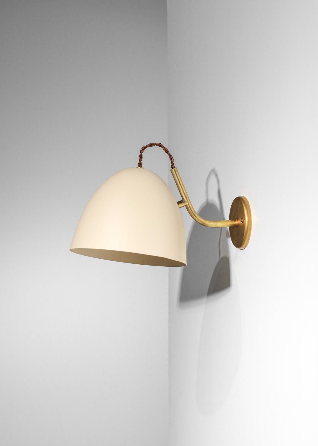 This pair of wall lights is made up of a lacquered metal lampshade with textured white paint and a solid brass structure. We recommend one E14 type LED bulb per wall light.