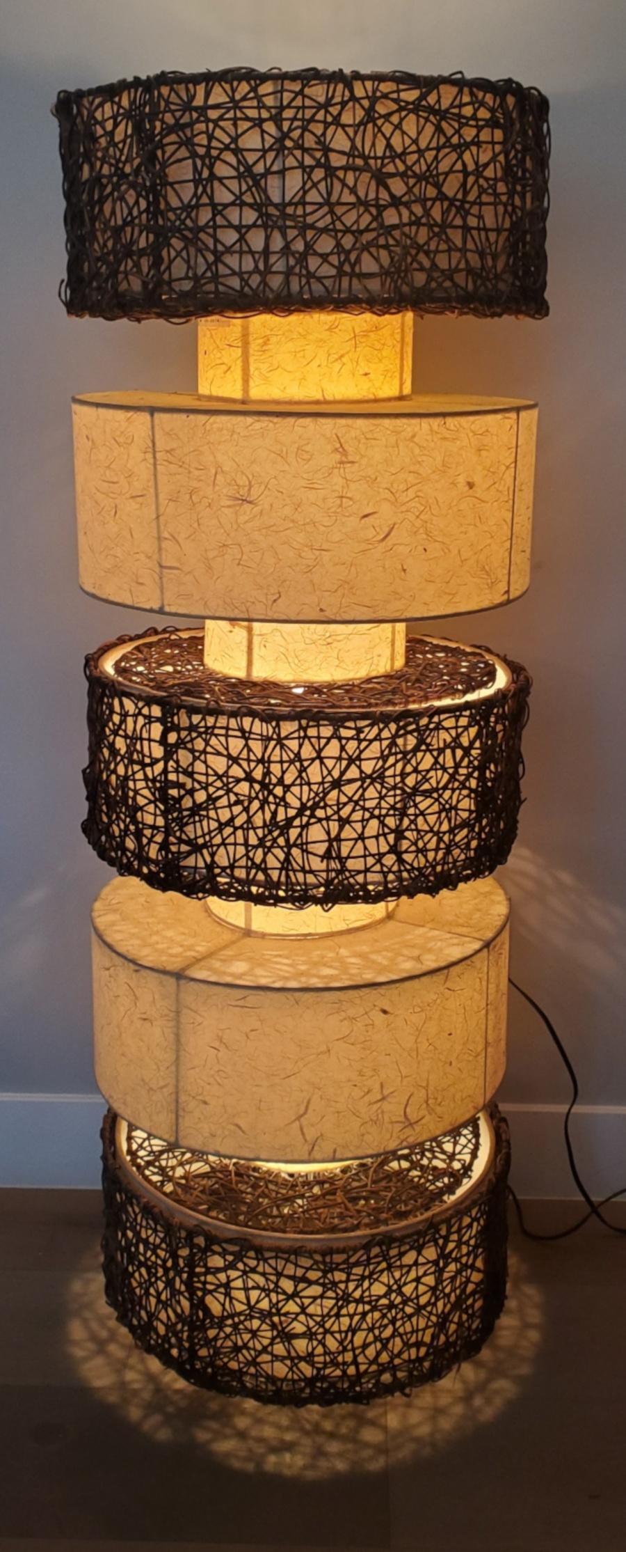 Stunning glowing pair of modern cylindrical tiered floor lamps in rattan and fiber glass. Beautiful glow and shine.