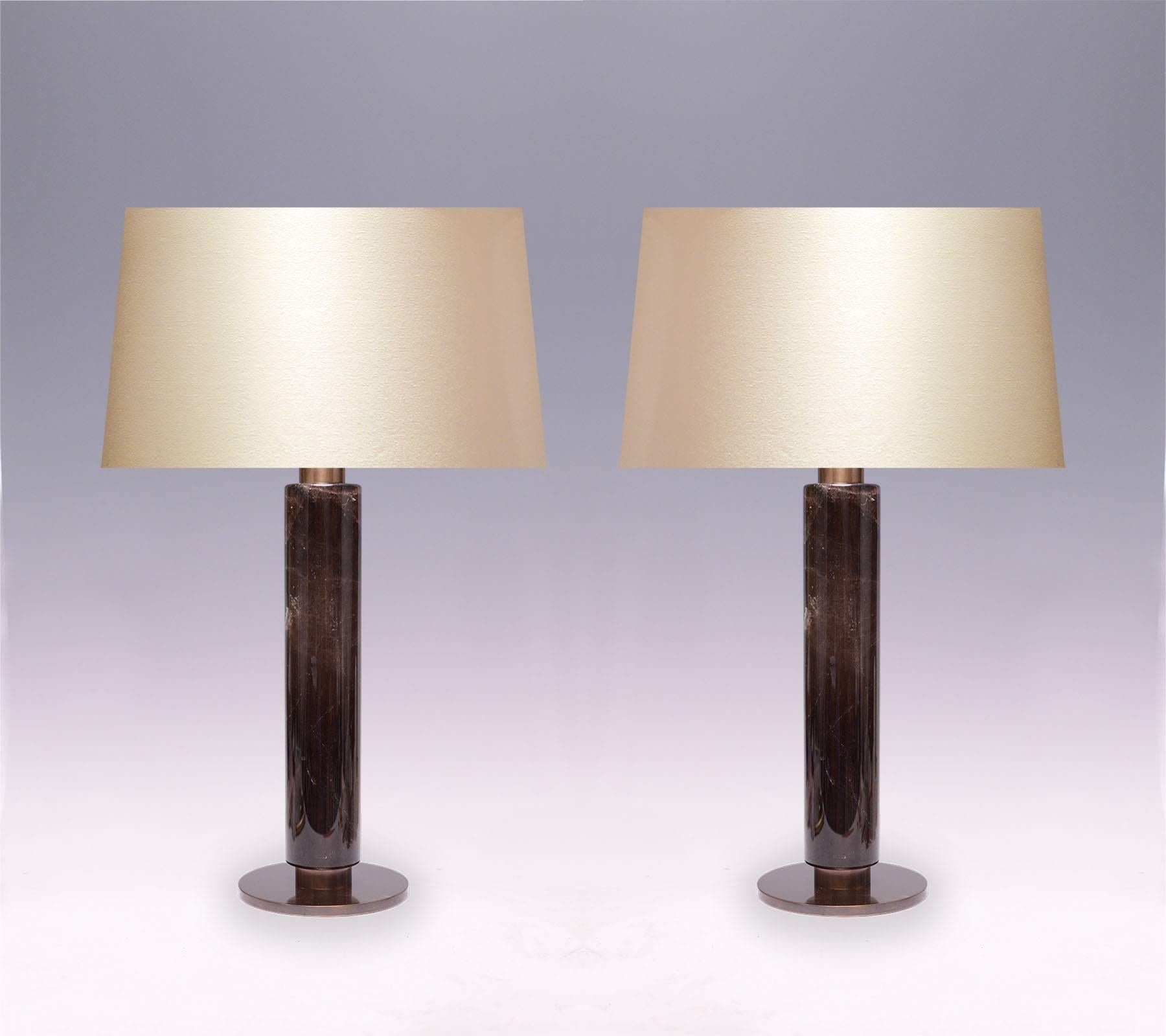 A pair of fine carved cylindrical form of dark rock crystal quartz lamp with antique brass bases. Created by Phoenix Gallery, NYC. 
To the rock crystal: 15