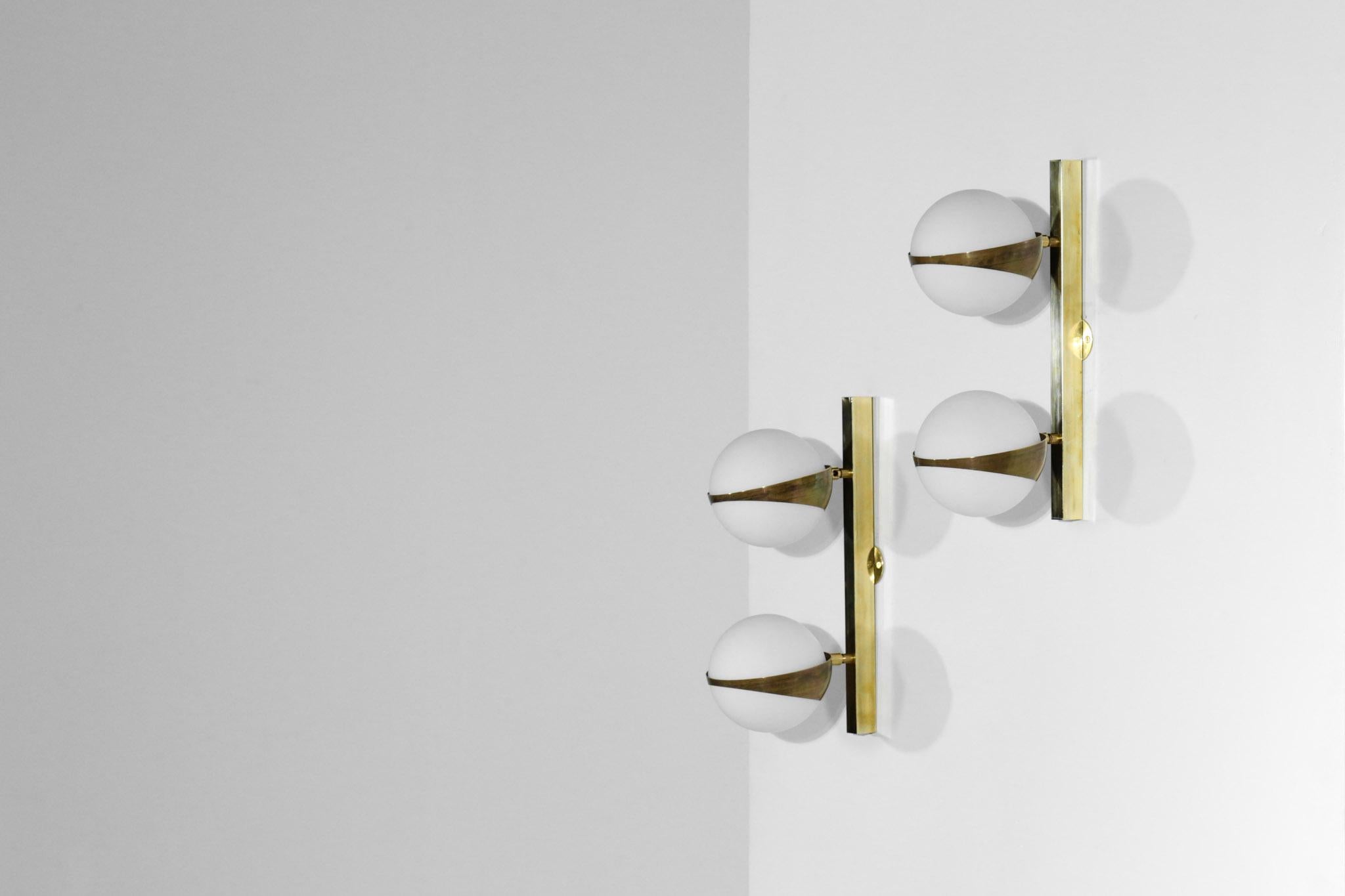 Nice pair of modern wall lights in the style of Stilnovo. 
Composed of 2 adjustable lights made of opaline glass and brass.

Custom on request.