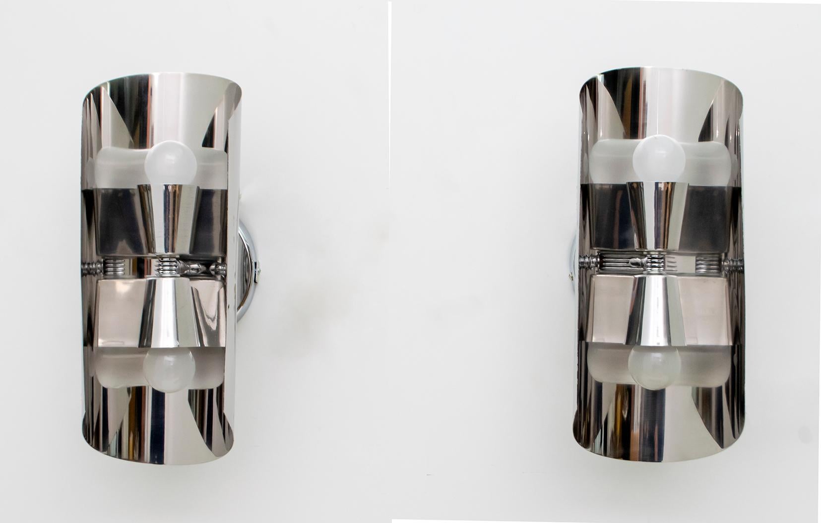 Pair of modern curved steel wall lights, designed in the style of Maria Pergay, France, 1970s. The sconces are created in a futuristic shape and have clean design features.