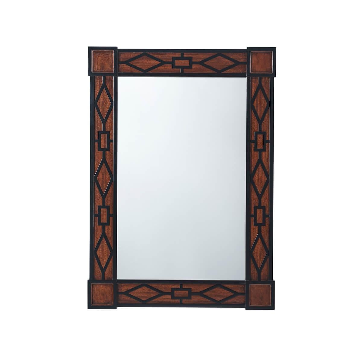 A Modern designed fretwork wall mirror that takes its timeless form from a pair of Chinese Chippendale mirrors. The rectangular mirror plate is set in a relief geometric fretwork paneled Mahogany veneered frame.

Dimensions: 32.75