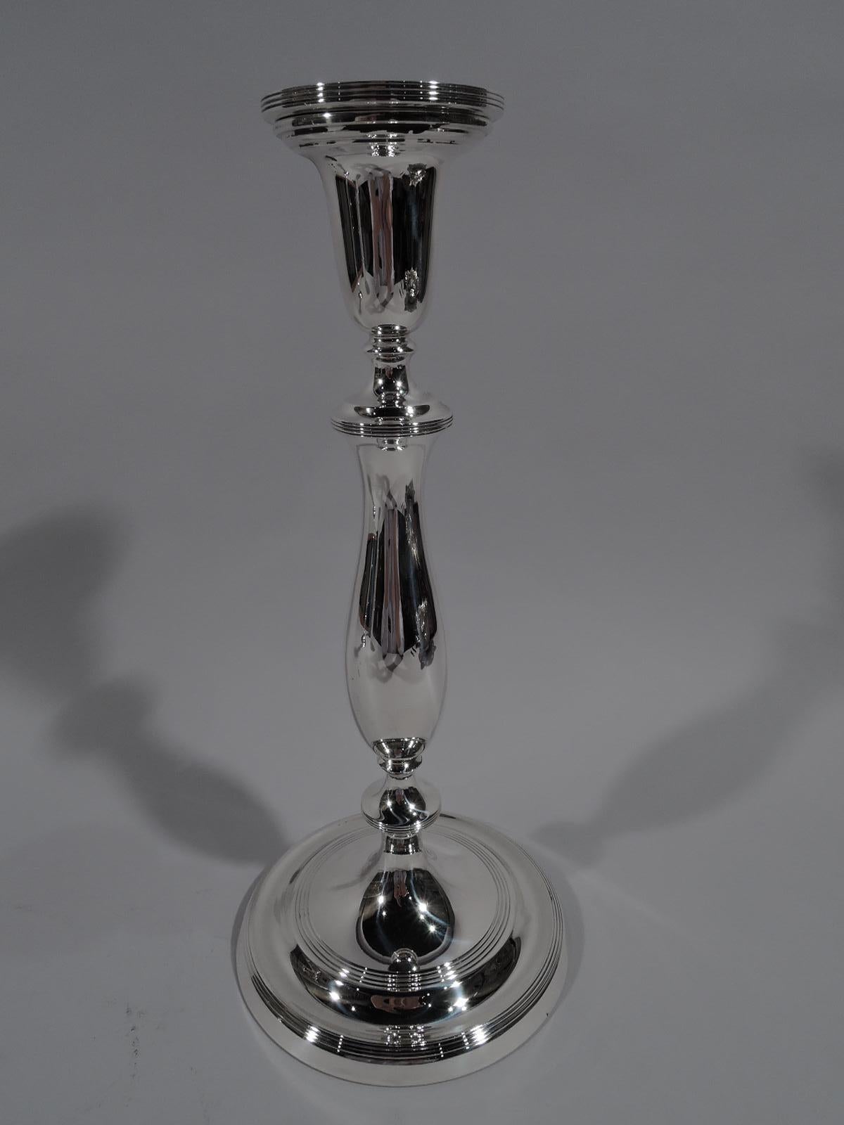 Pair of Modern Georgian sterling silver candlesticks. Made by Blackinton in North Attleboro, Mass., circa 1940. Knopped baluster shaft on domed foot. Reeding. A voluptuous interpretation of a traditional form. Fully marked and numbered A100.
