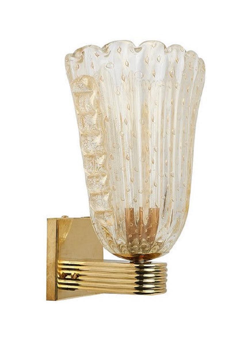 Pair of modern gold colored Murano glass wall lamps on ribbed brass base, Italy 1980s.

The conical gold transparent glass shade has gold particles and air bubbles in the glass mass, it is also ribbed.
On the right and left side runs a glass