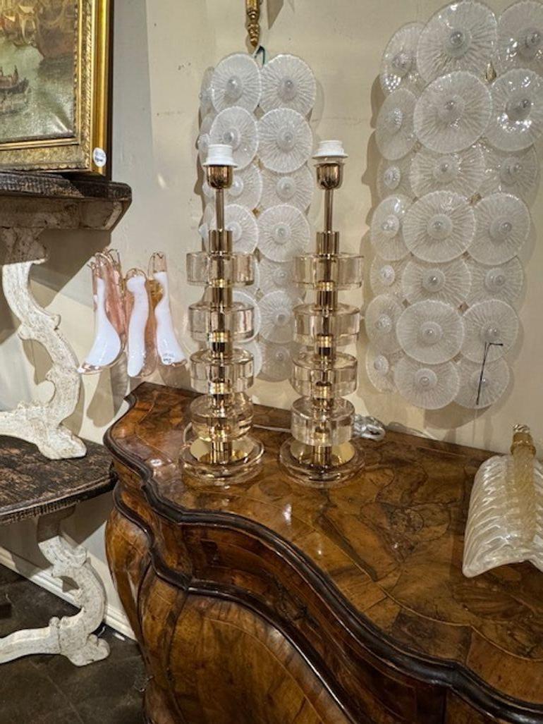 Gorgeous pair of gold Murano glass and brass disc lamps. Creates a beautiful upscale modern look!
22h x 6.5w