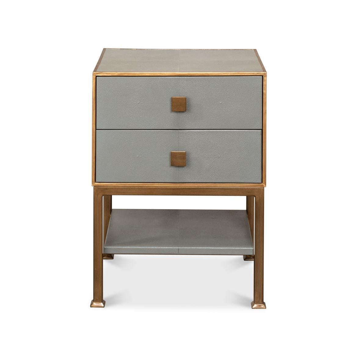 A streamlined design with its sleek embossed leather framed in a lustrous gilt finish. The two stacked drawers, adorned with simple square pulls, offer a discreet storage solution, while the lower shelf is perfect for stacking books or displaying