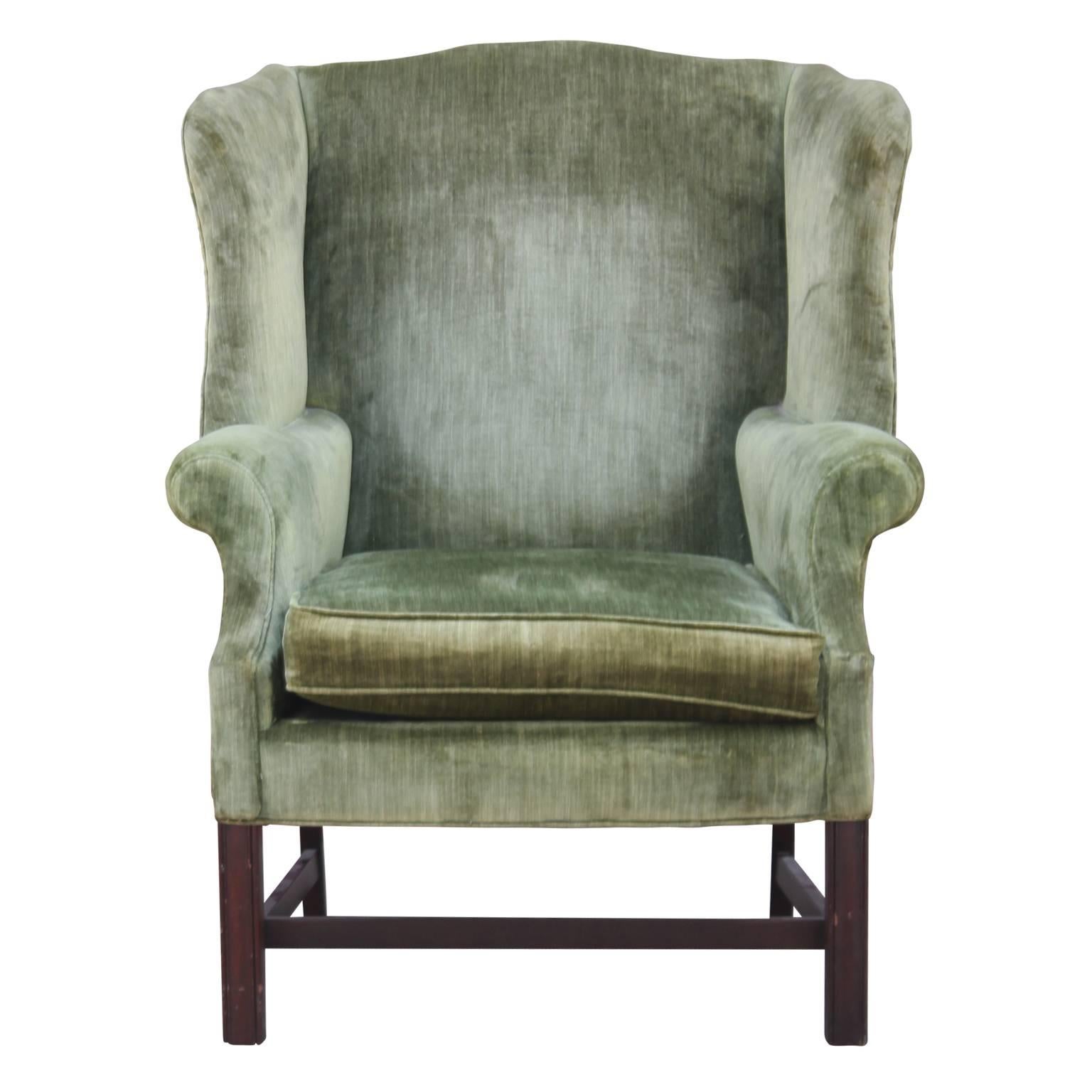 Pair of modern green velvet mahogany wingback lounge chairs.