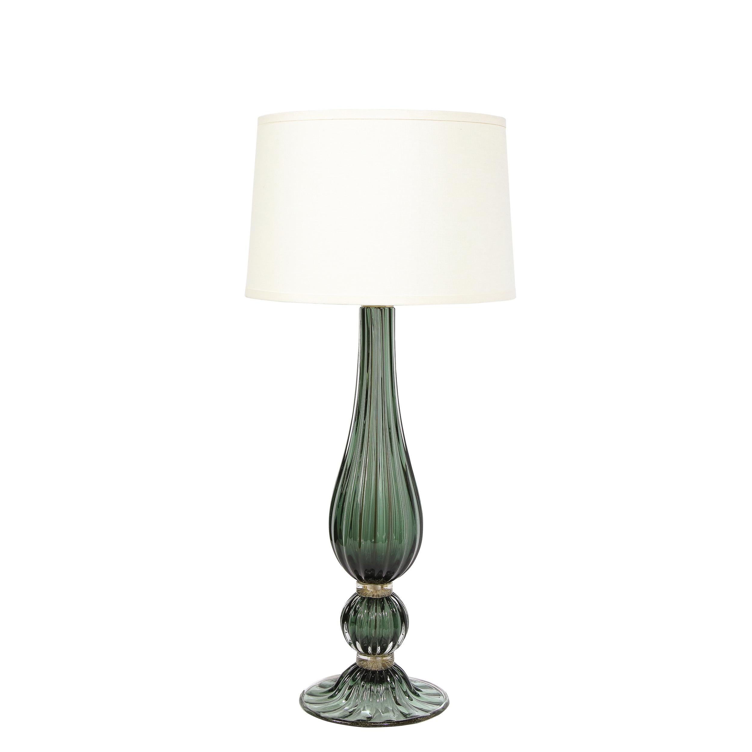 This stunning pair of table lamps were handblown in Murano, Italy- the island off the coast of Venice renowned for centuries for its superlative glass production. They feature tear drop form bodies in handblown translucent reeded glass banded near