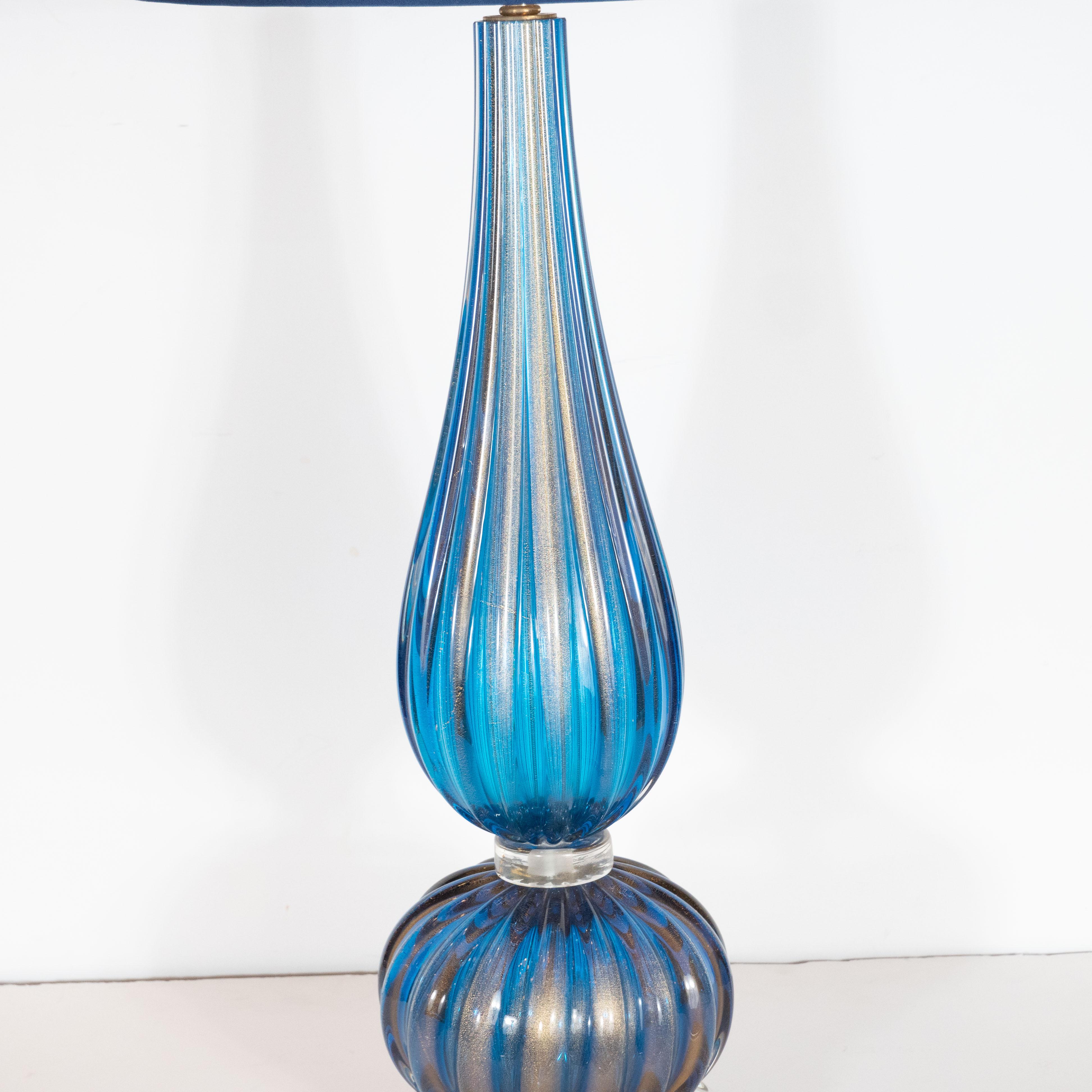 This stunning pair of table lamps were handblown in Murano, Italy- the island off the coast of Venice renowned for centuries for its superlative glass production. They feature tear drop form bodies in handblown reeded glass in a rich royal blue hue