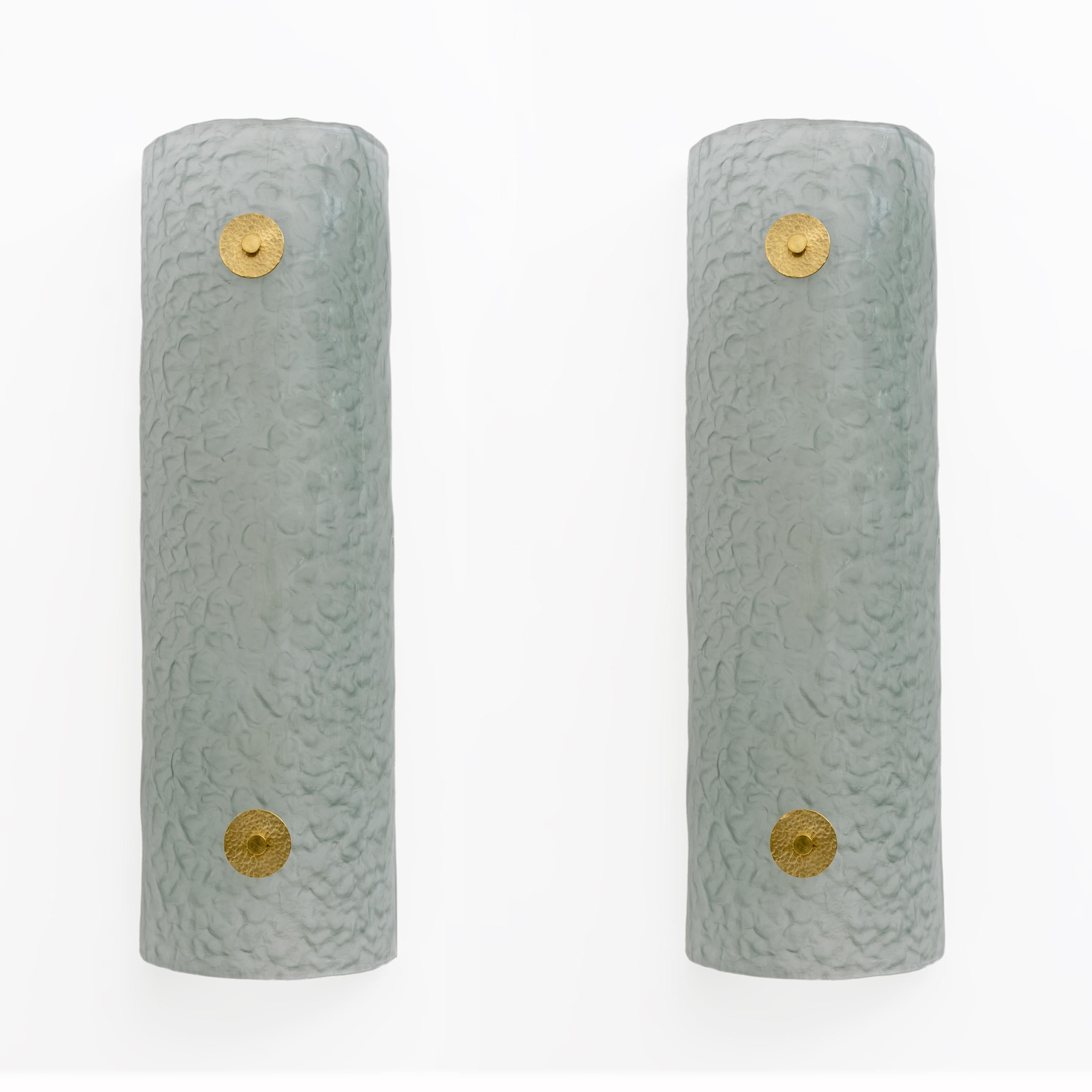 Pair of aqua green Murano glass wall lights with a frosted back and textured look. Each light is made from a single curved glass, supported by two brass bolts. They are high quality and give off a nice warm light. Each light contains four medium