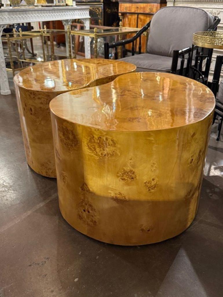 These modern kidney-shaped tables are reminiscent of the iconic designs by Milo Baughman, featuring a sleek and stylish burlwood.  With a kidney shape, these tables add a unique touch to any living space, combining mid century modern charm with a
