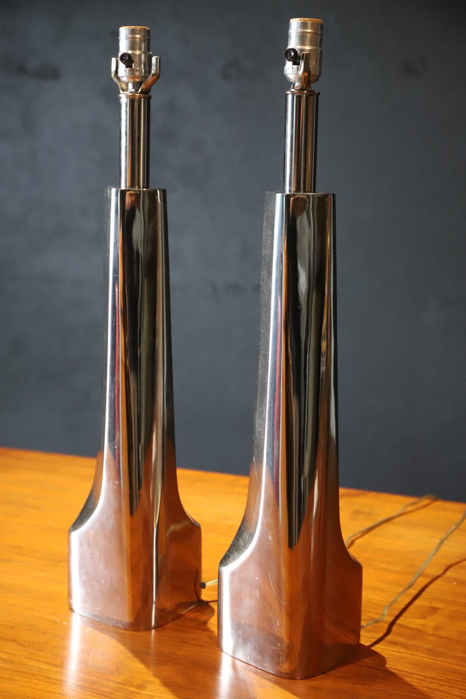 Pair of cast aluminum, Mid-Century lamps by Laurel Lamp Company. Brushed center with polished body. Features 3 way socket. Sleek & modern, these are a wonderful add to any room. Sold without shades & harps (shown only for scale). Made in the USA.
  