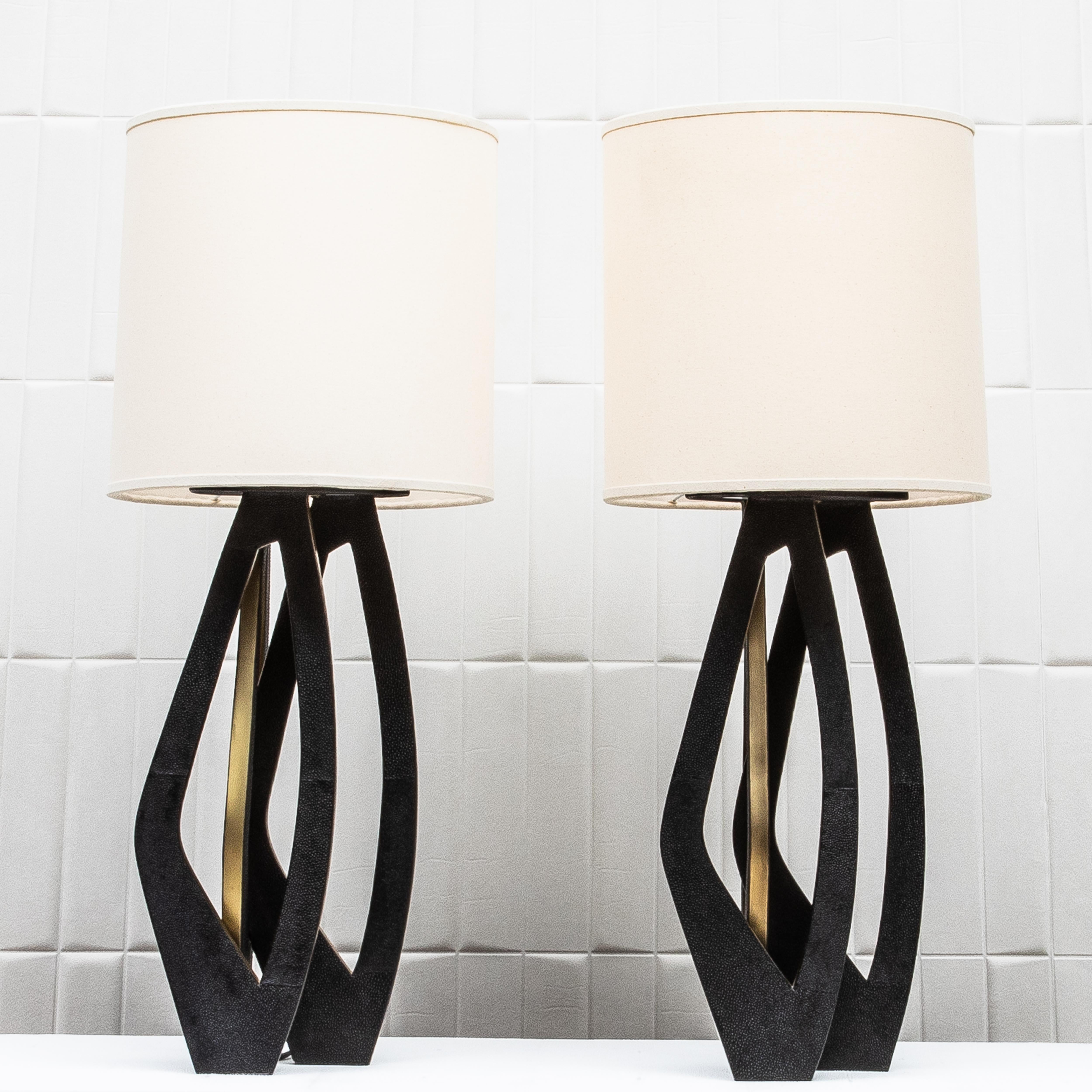 The Petal Lamps by R&Y Augousti are a striking testament to contemporary design infused with timeless elegance. These sculptural table lamps feature an exquisite interplay of materials, combining the luxurious texture of hand-laid black shagreen