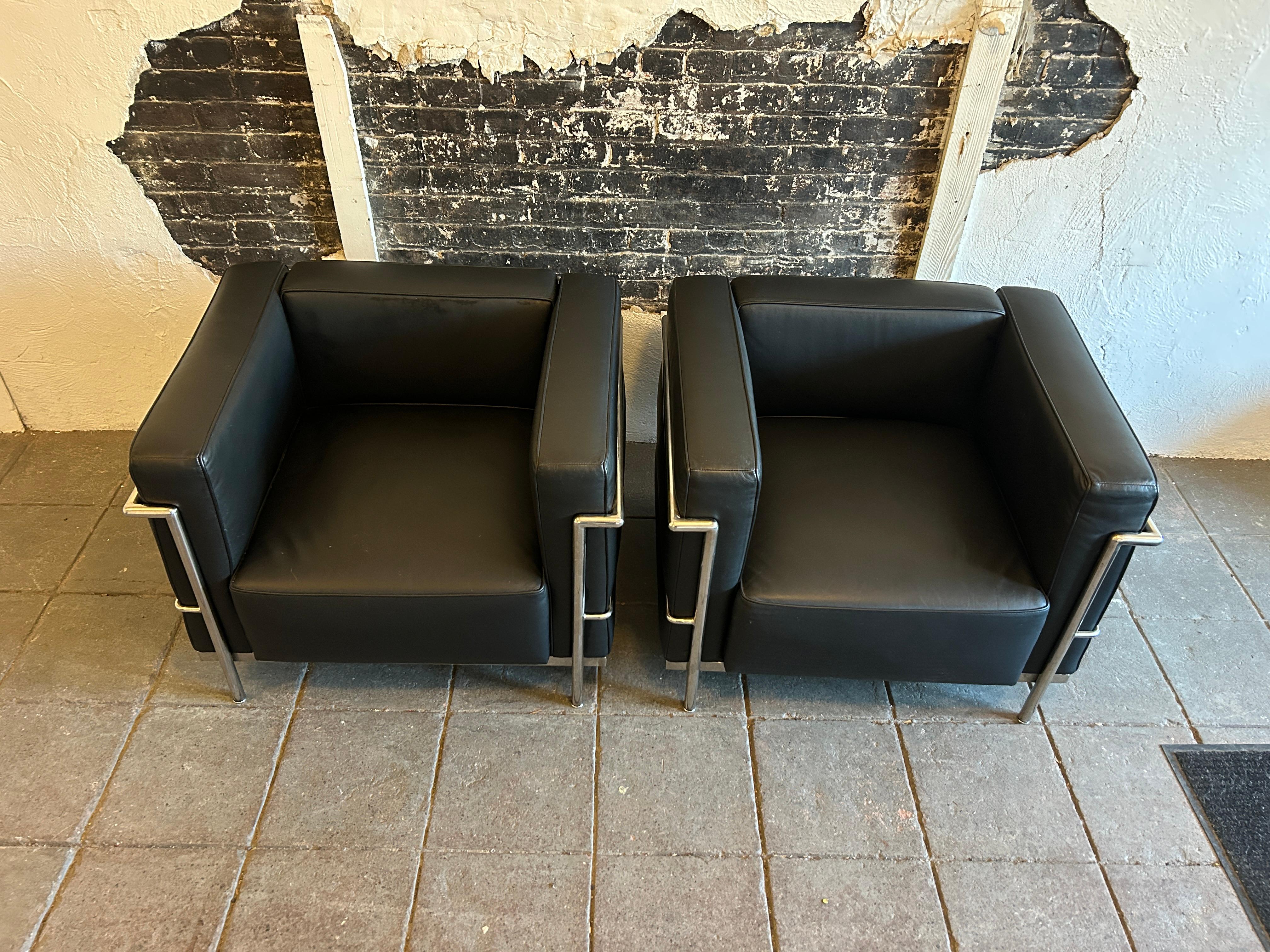 A pair of pre owned modern lounge or club chairs by Le Corbusier. Wide Model LC3 in soft black Leather. Triple chrome plated steel frames. Show little to no signs of use. Made in italy. Located in Brooklyn NYC.

Sold as (1) Pair Set of (2) Chairs as