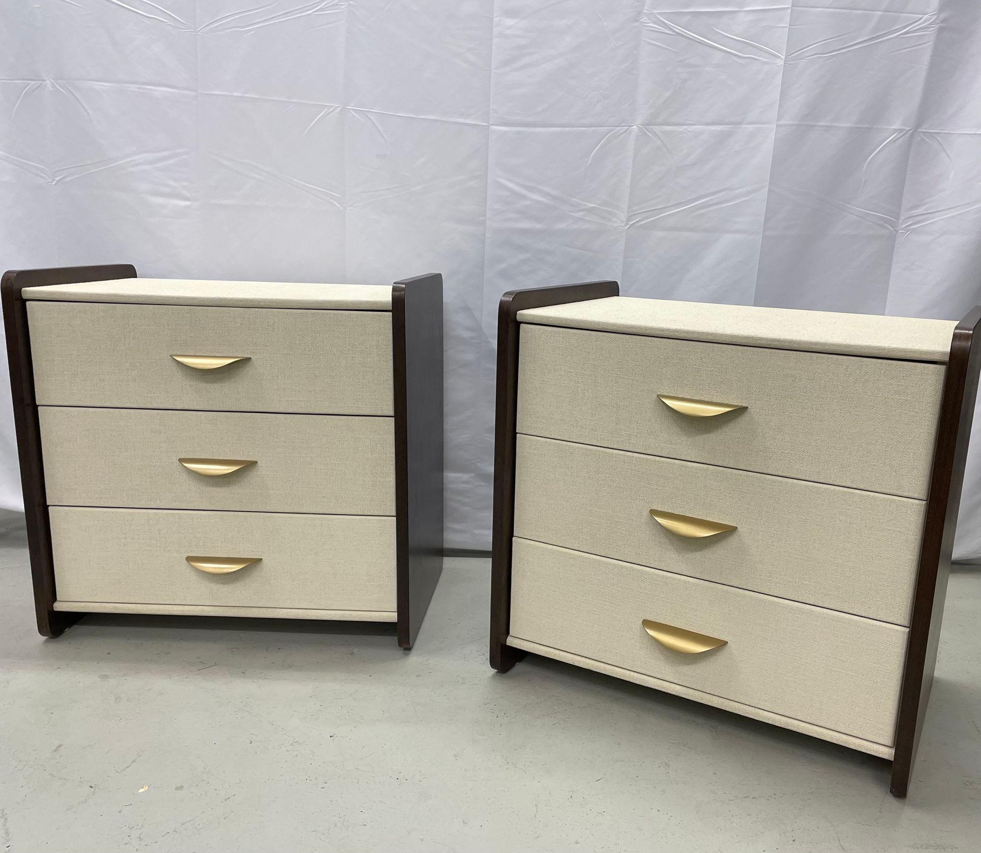 Pair of modern linen chest, nightstands, dressers, walnut, custom American.
Custom quality pair of three drawer modern decorative cabinets. Each on floating sides, hand wrapped in linen and given a multi-layered paint glaze in a neutral oyster