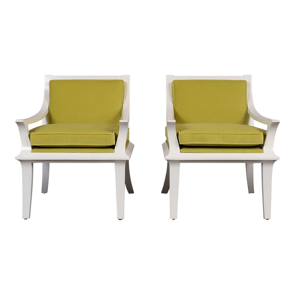This Pair of Vintage Modern Lounge Chairs are made out of solid wood that has been newly stained a white color with a lacquered finish and is fully restored. The armchairs feature elegantly carved armrests/frames, have been upholstered in a new
