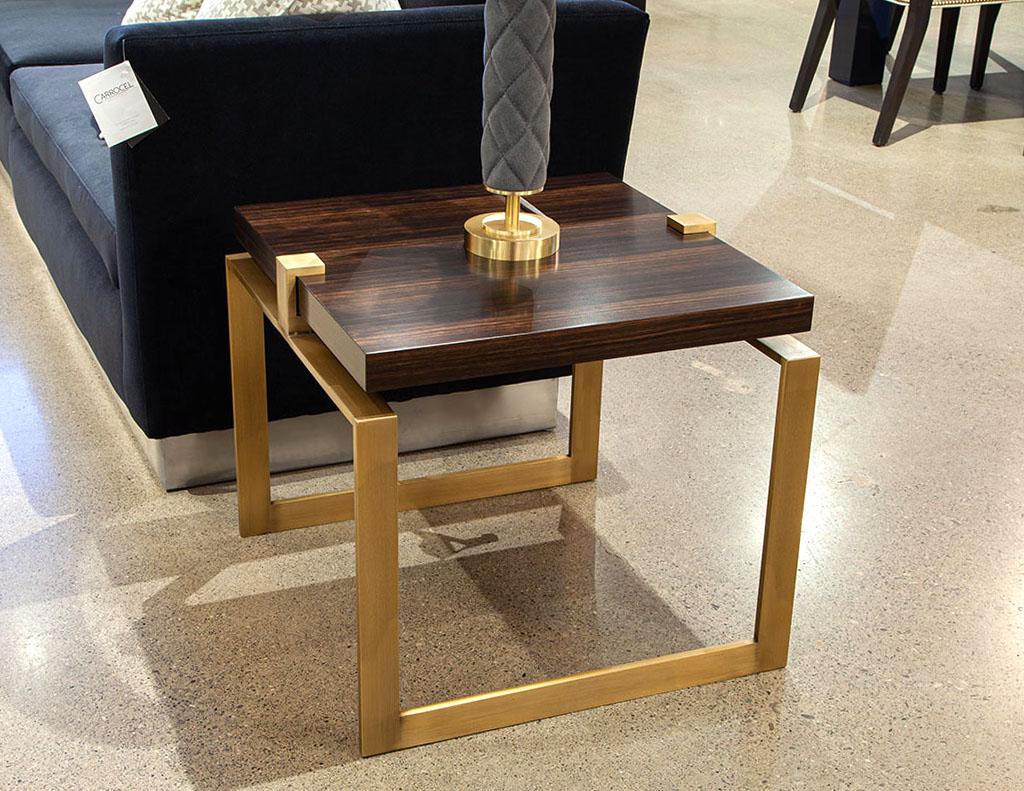 Pair of Modern Macassar and brass end tables. Custom made by the artisans at Carrocel in Toronto, Canada. Modern brass metal cubed frames with floating macassar wood tops. Finished in a rich macassar color with satin brass frames. The perfect