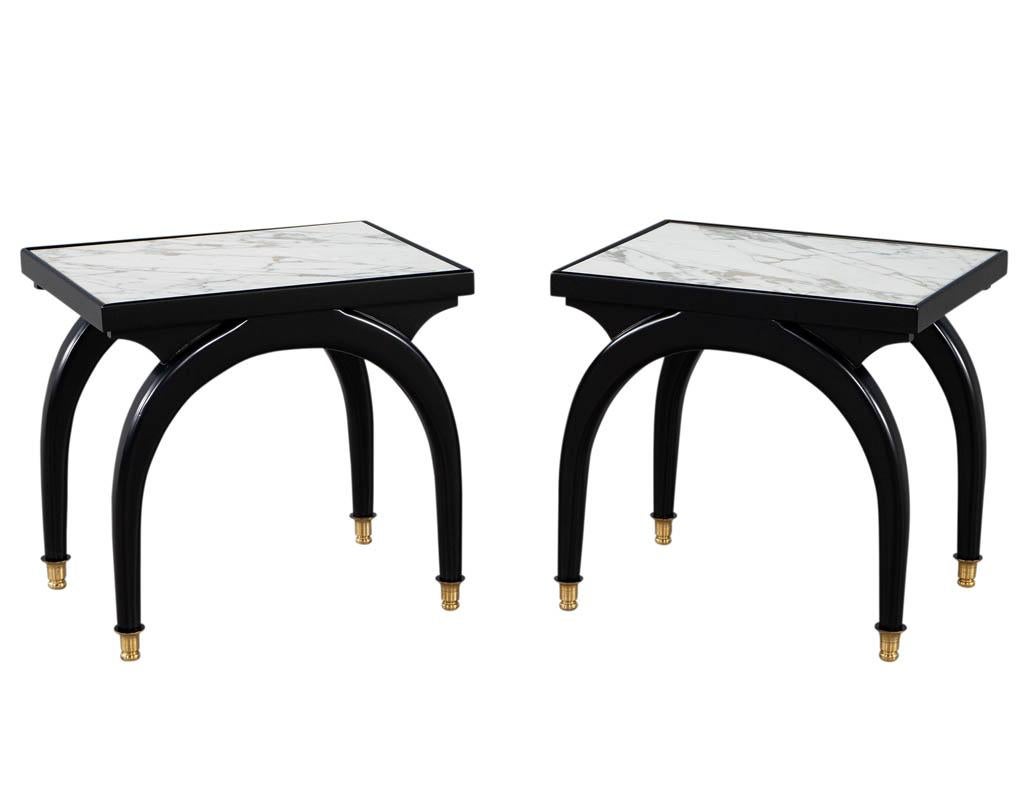 Pair of modern marble top black and white end tables with curved legs. Featuring beautiful 2 tone marble tops with unique curved leg design. Finished in a satin black lacquer with brass capped feet. Originals from the 1980's, made in USA, restored