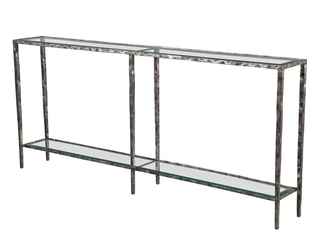Pair of modern metal console tables with hammered details by Maitland-Smith. Sleek modern hand forged iron frames with incredible hammered design creates a bold and unique look. Featuring a rustic antiqued French Iron color palate with large,